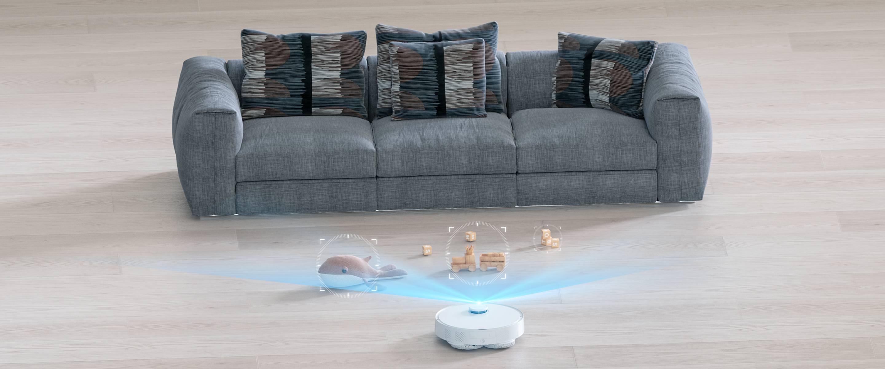 Un aspirapolvere robot con un divano sullo sfondo e giocattoli davanti.
