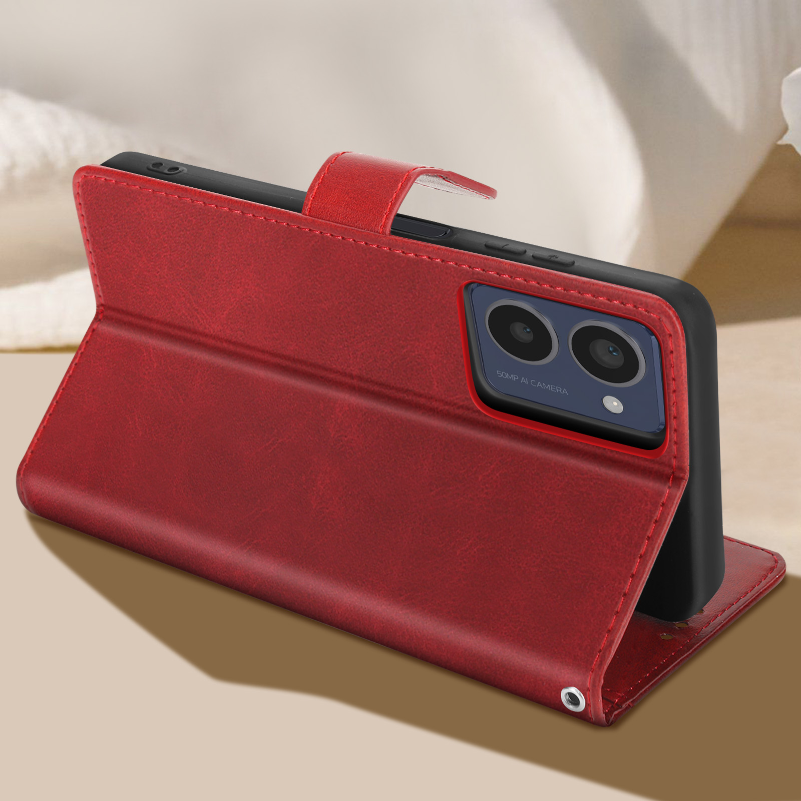 Una custodia per telefono in pelle rossa con un telefono dentro. La custodia è aperta, il telefono è appoggiato.