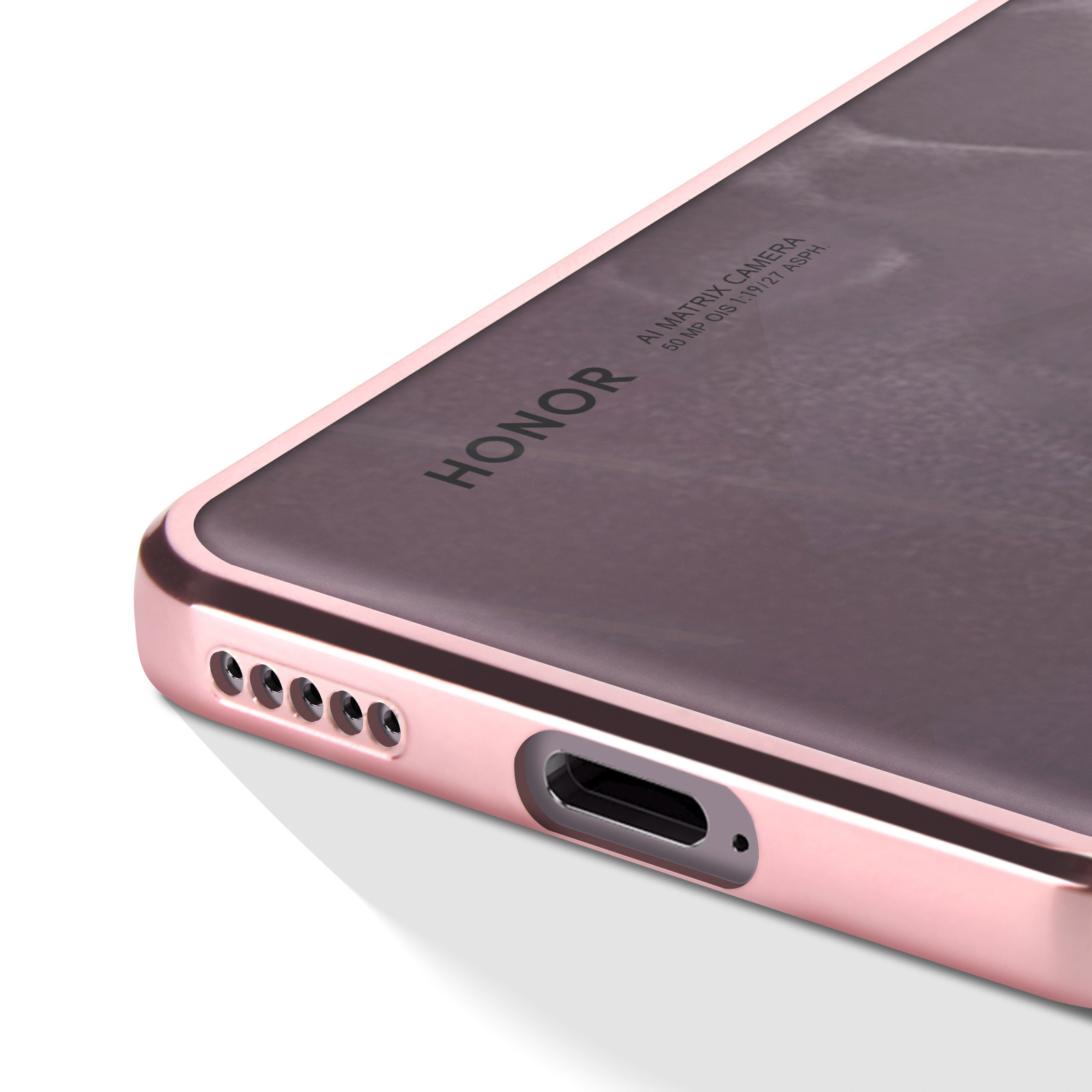 Primo piano del bordo di un telefono rosa. Ha fotocamera, porte e un logo 'Honor'.