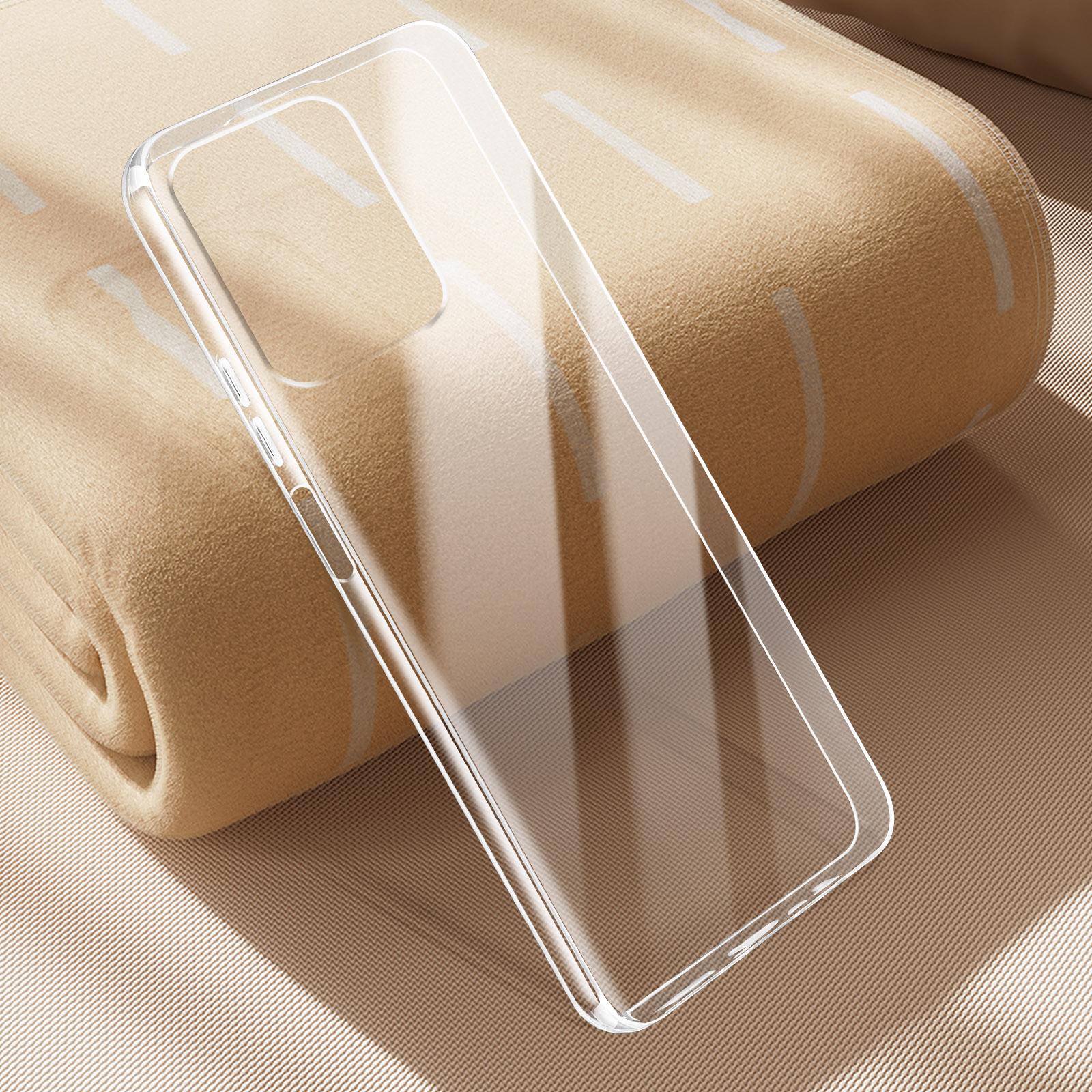 Custodia trasparente per telefono su una coperta beige. La custodia è vuota.