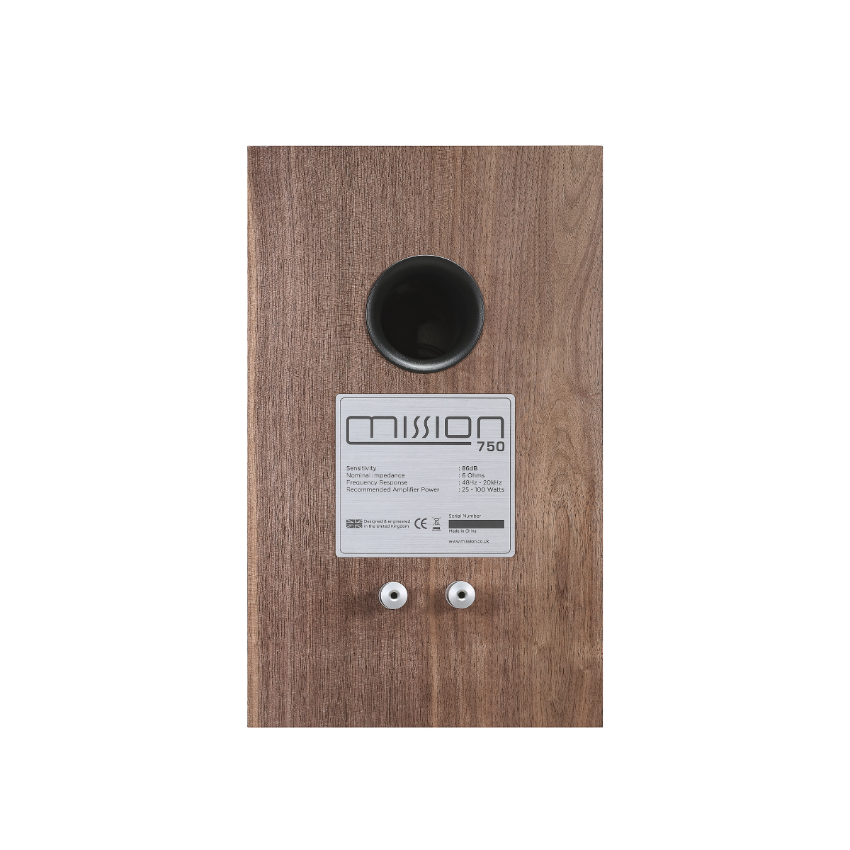 Speaker back with a label. Brown wood, a black hole and white backdrop.