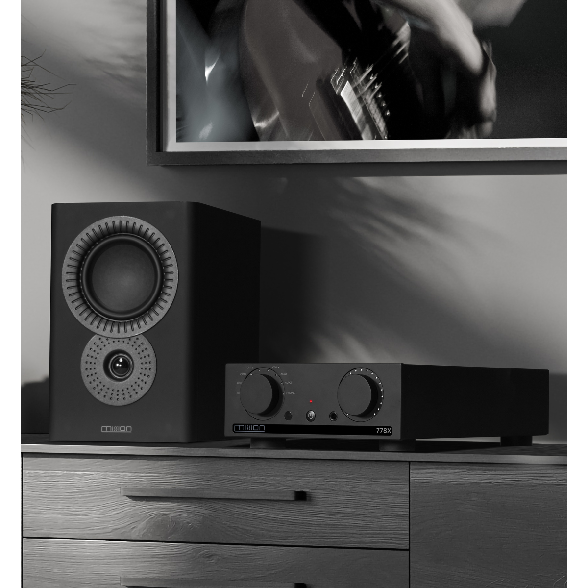 Black audio system with speaker and amplifier on a cabinet.
