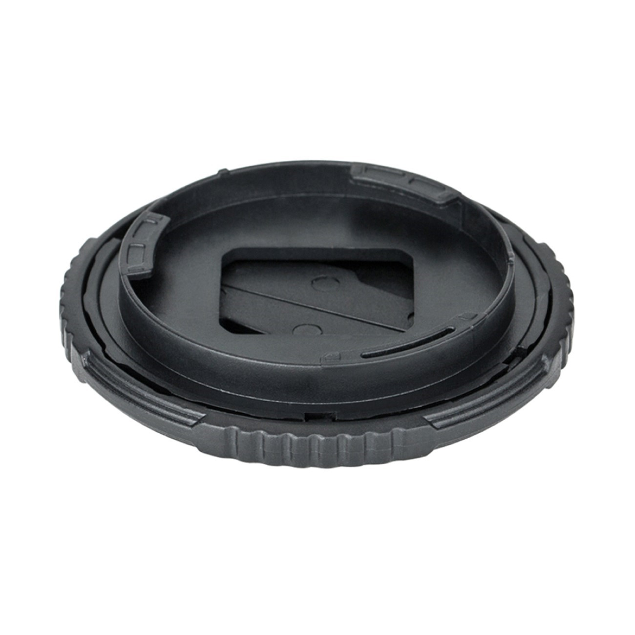 Schwarze Objektivkappe, kreisförmig, mit quadratischer Mitte und Rillen.
