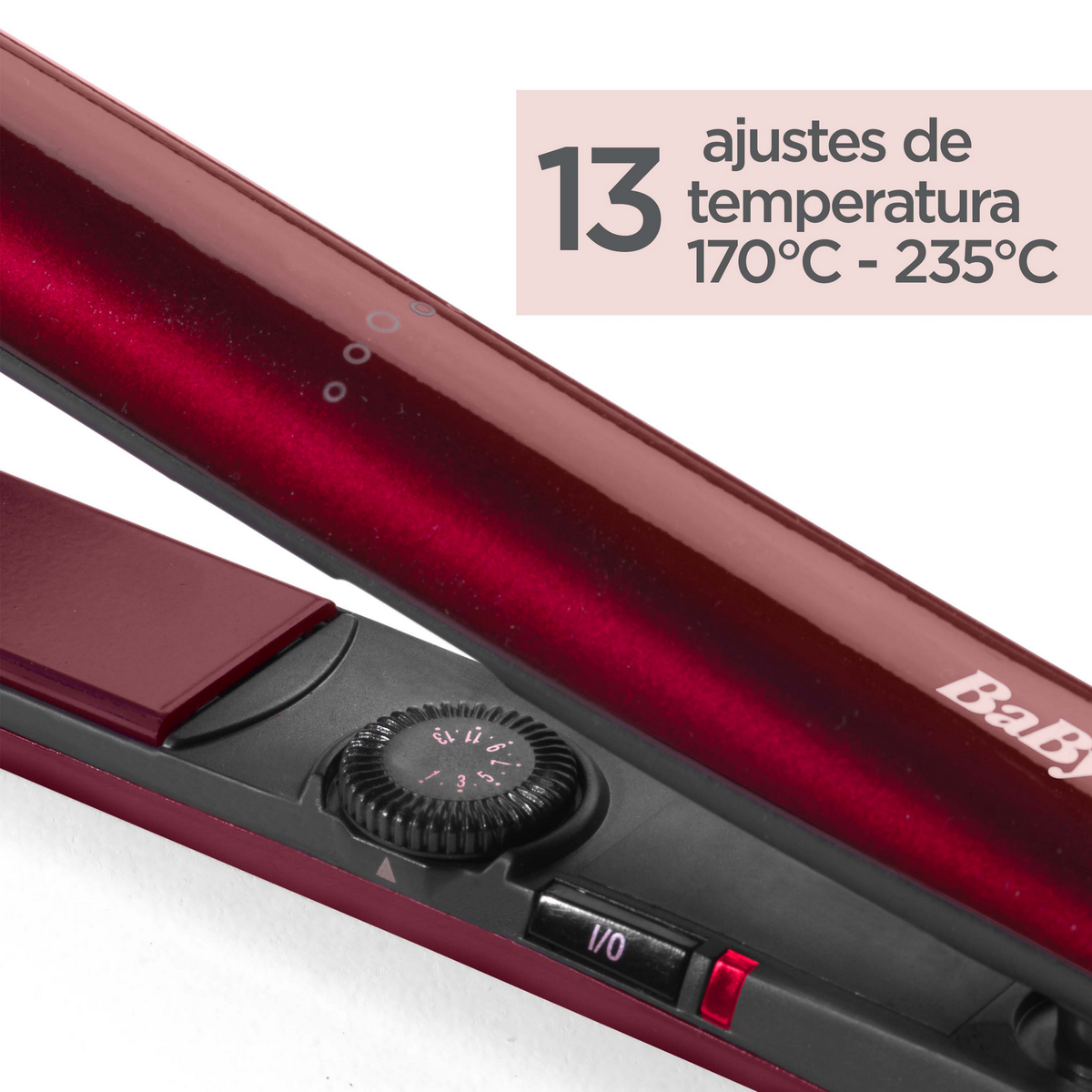 Piastra per capelli rossa con impostazioni della temperatura. Un quadrante nero con l'impostazione della temperatura.