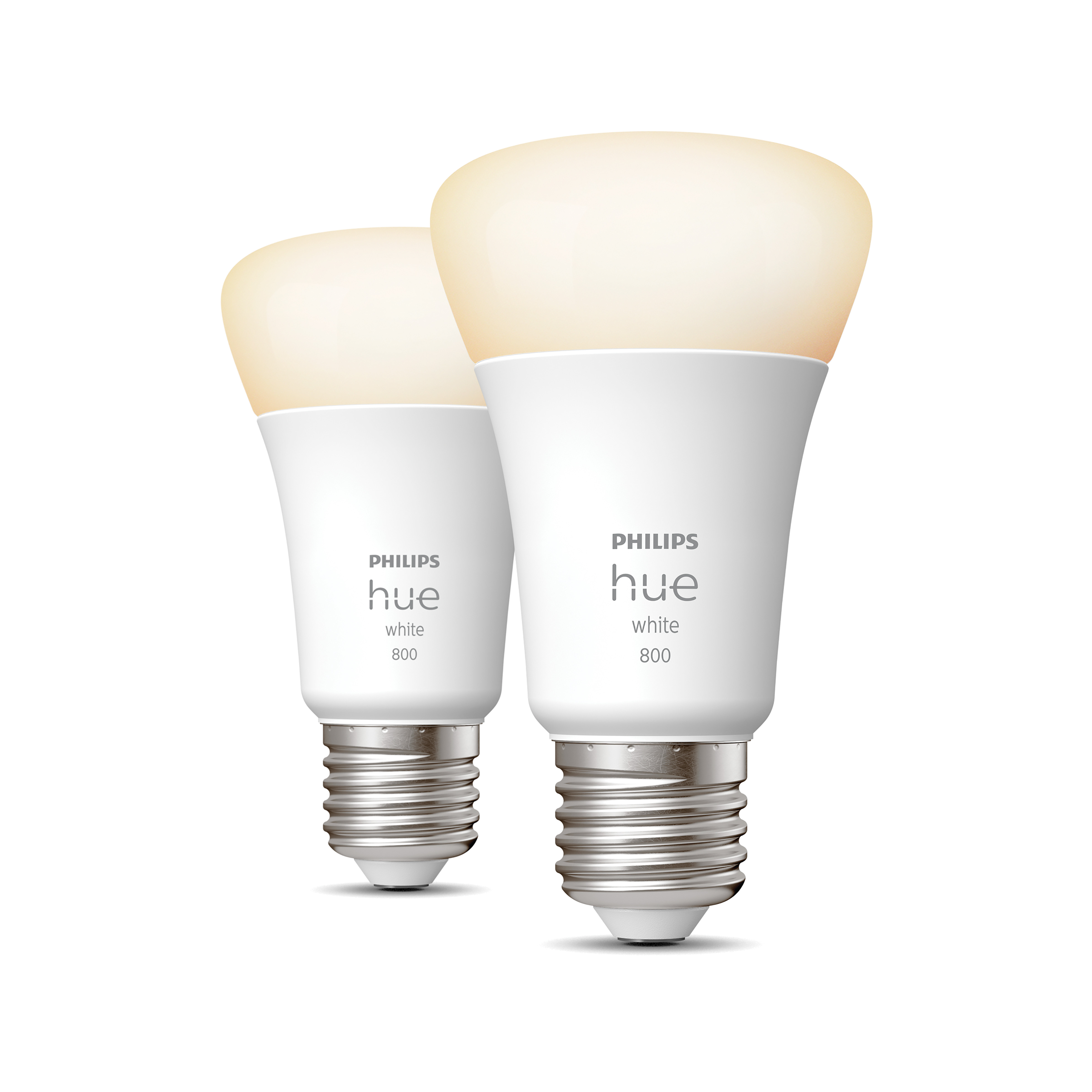 Deux ampoules blanches Philips Hue, légèrement inclinées. Les ampoules ont une lueur blanche et jaune.