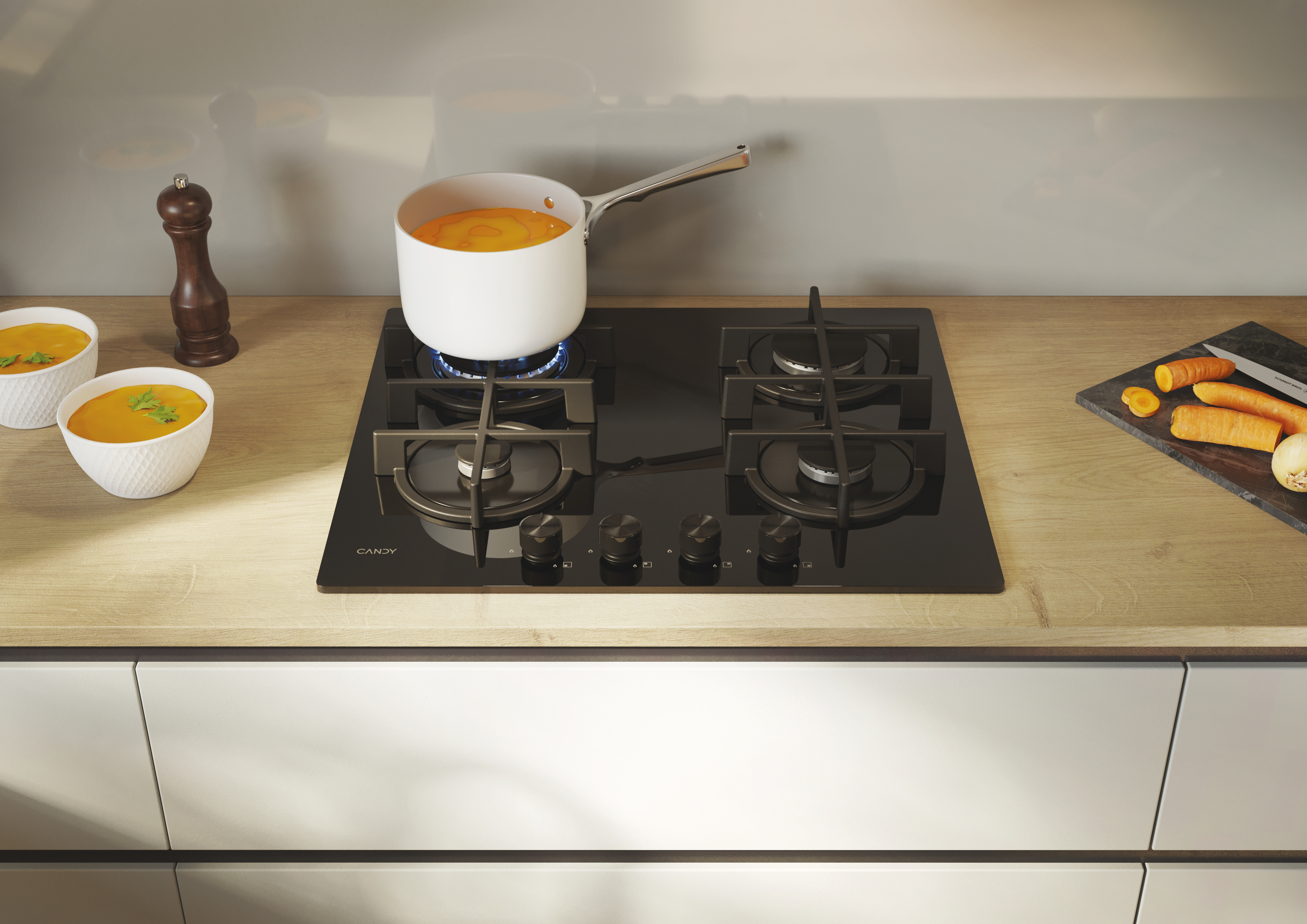 Czarna płyta kuchenna z czterema palnikami, garnek na kuchence, jedzenie.