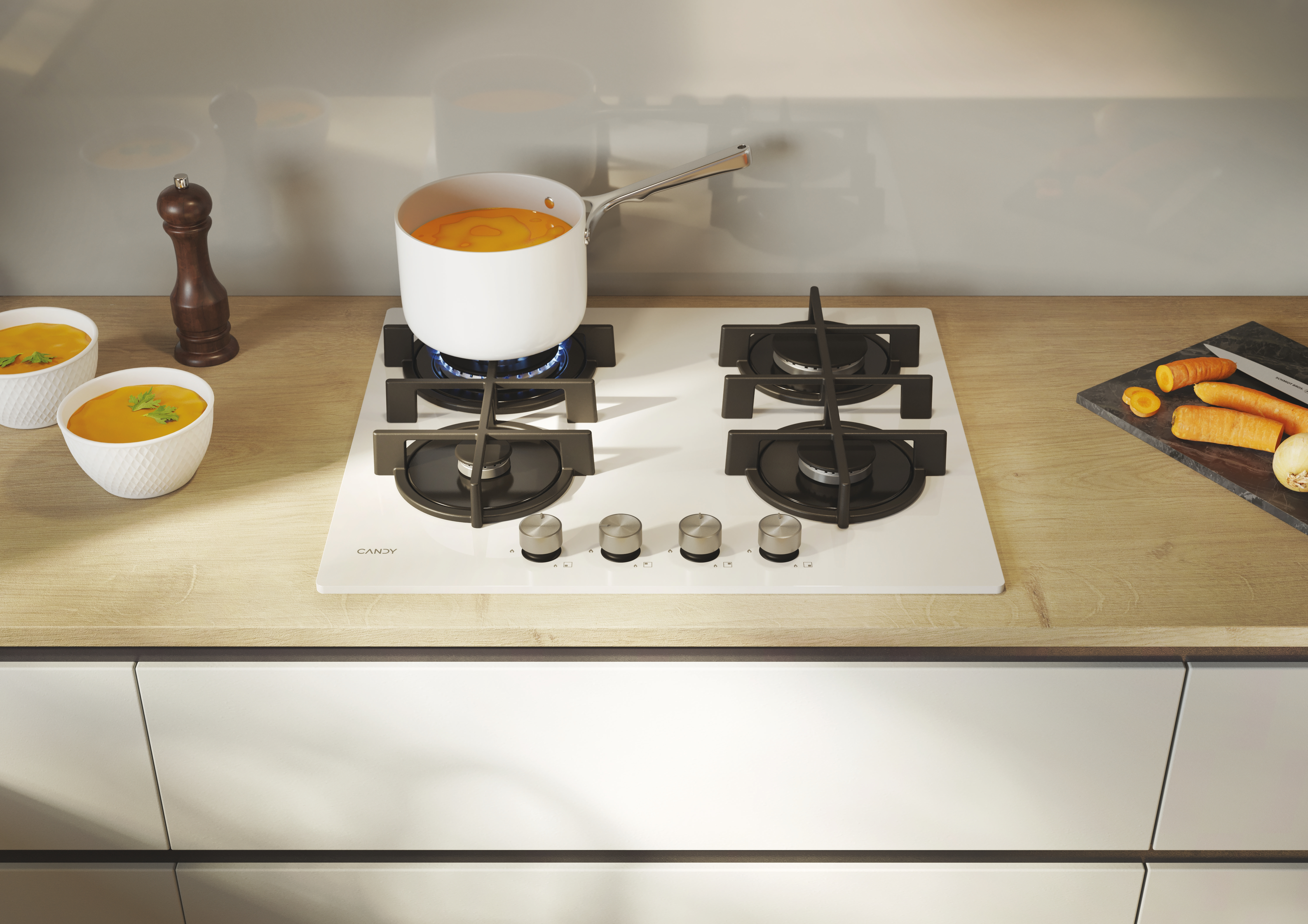 Biała kuchenka z czterema palnikami, garnkiem i warzywami.