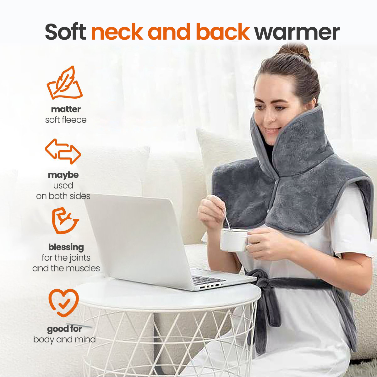 Woman wearing a gray neck warmer, using a laptop, holding a cup. Table with white object.