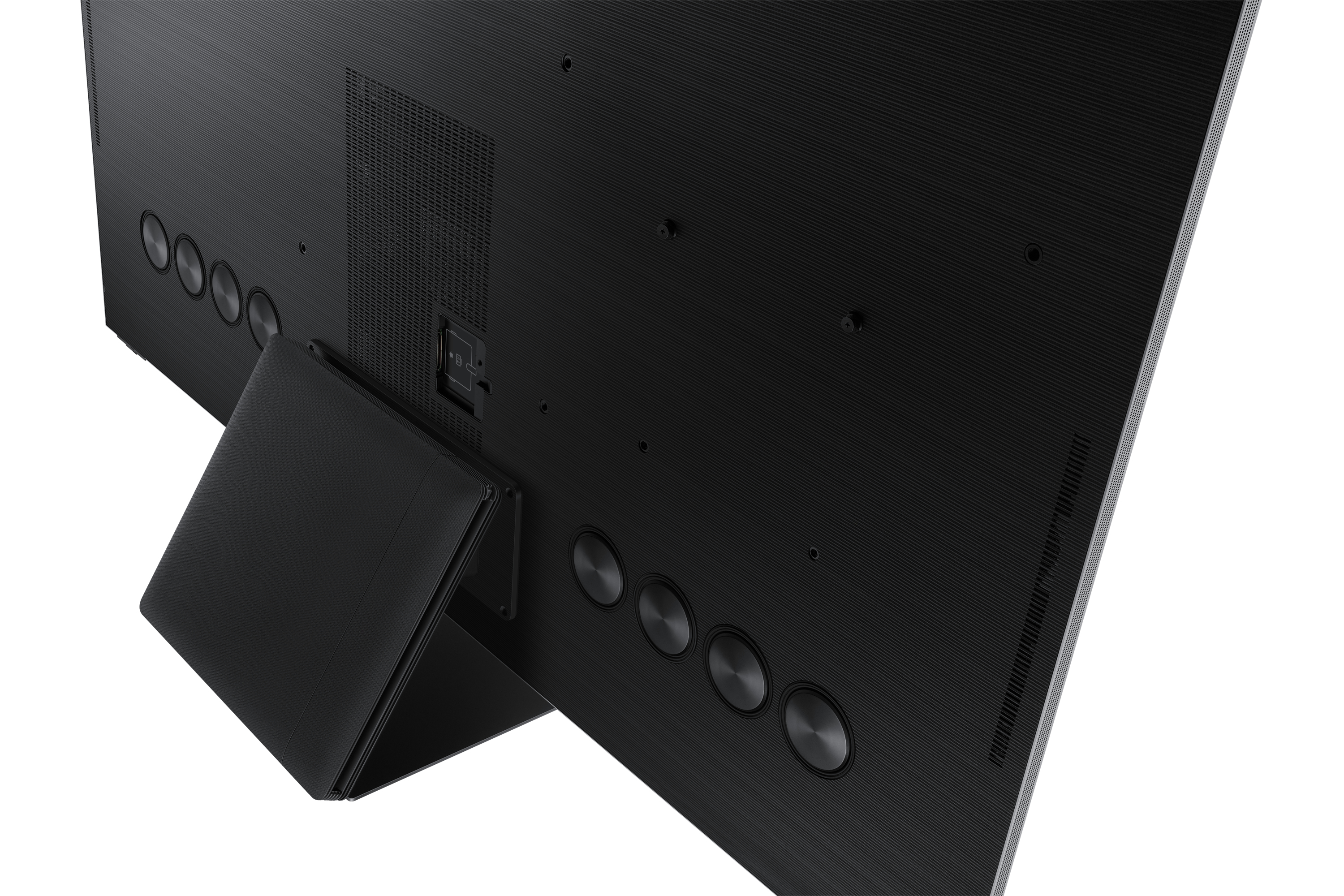 Parte trasera de TV negra con soporte. Detalles circulares y ventilación.