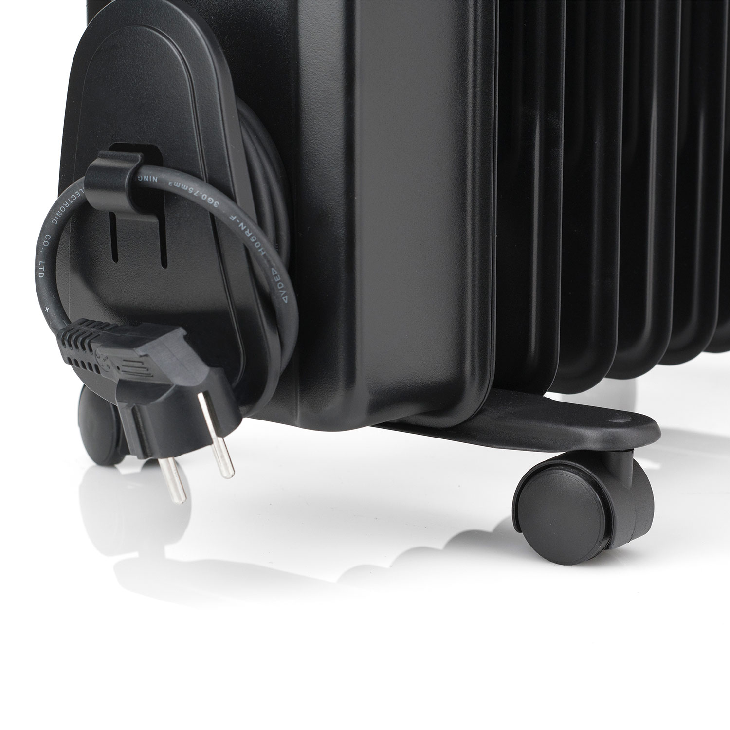 Czarny grzejnik olejowy z przewodem zasilającym i wtyczką, na białej powierzchni.