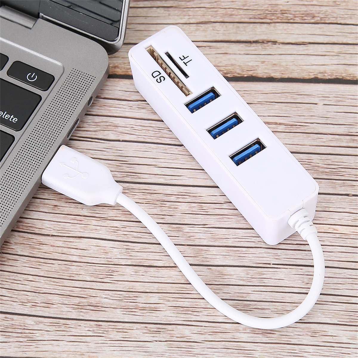 Weißer USB-Hub mit 3 USB-Anschlüssen, einem SD- und TF-Kartensteckplatz, an einen Laptop angeschlossen.
