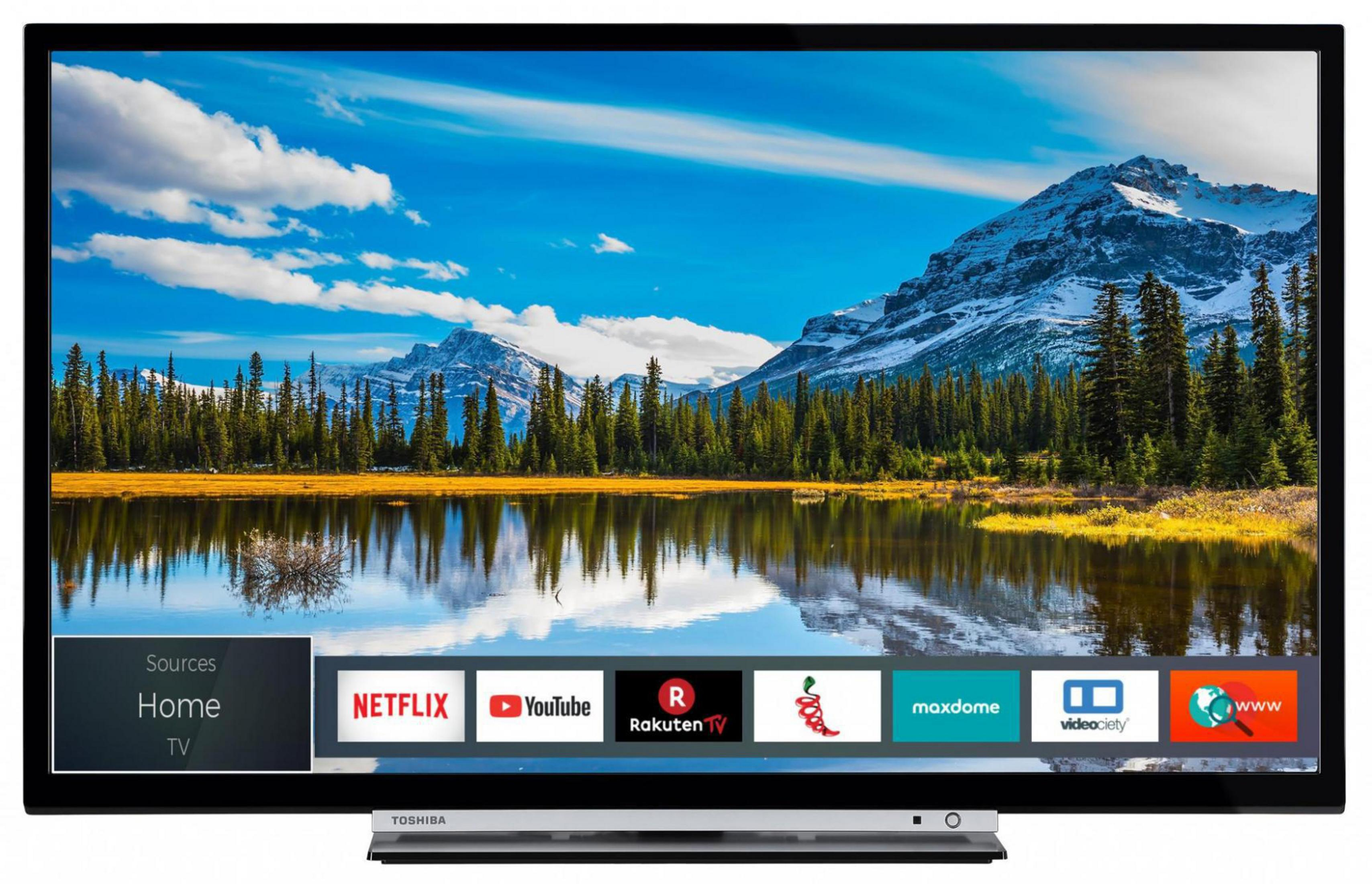 Una TV moderna che mostra un paesaggio panoramico con un lago e montagne, e icone di app.