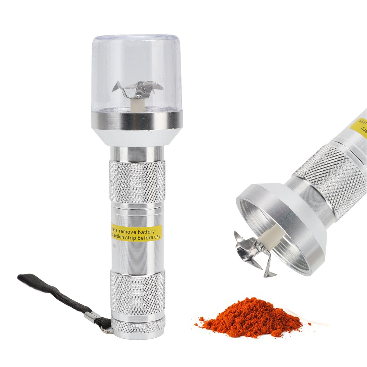 Ein silberner Grinder mit klarem Deckel. Es gibt rotes Pulver und ein schwarzes Schlüsselband.