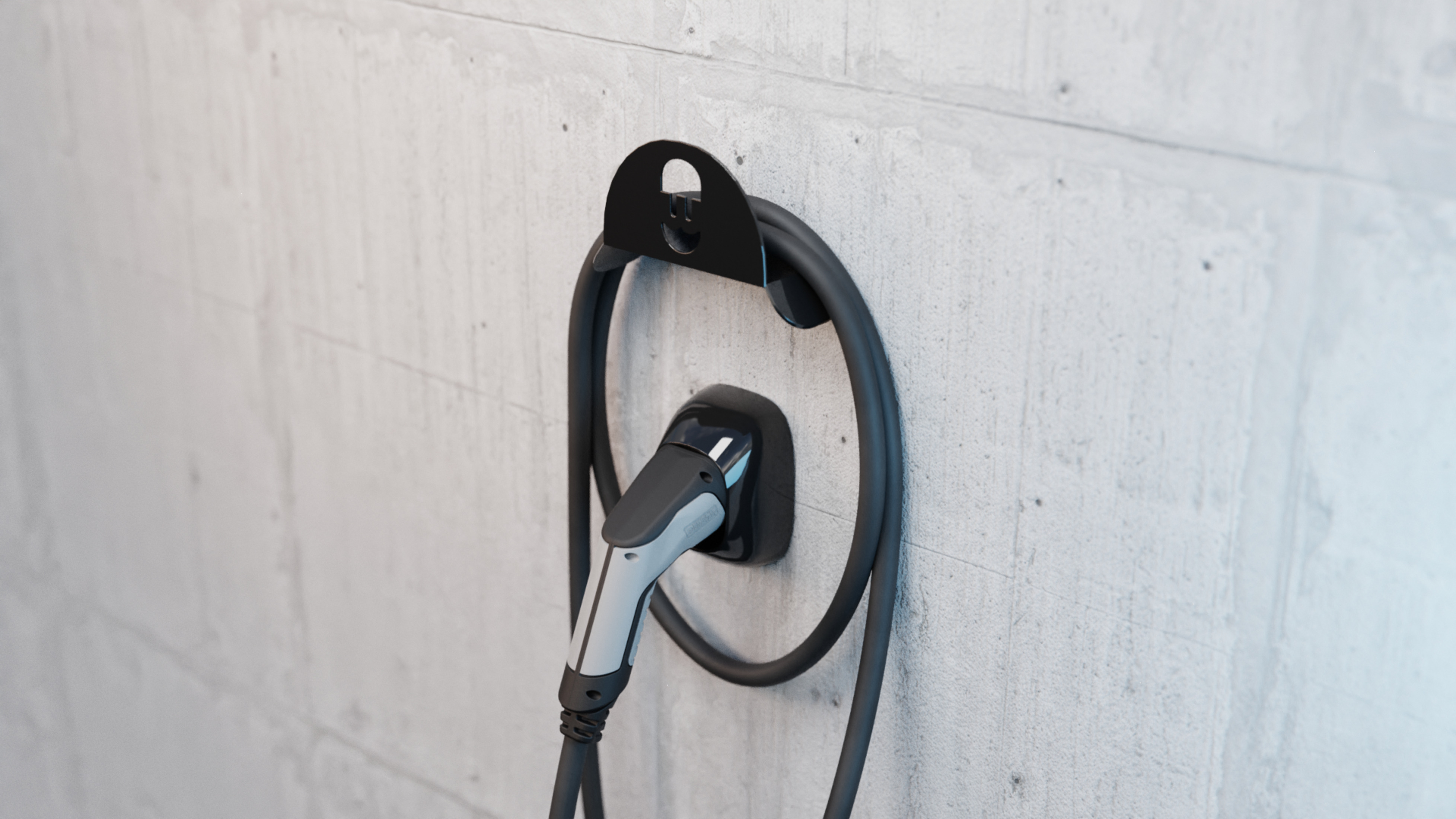 Eine Ladestation für Elektroautos an einer Betonmauer mit Ladekabel.