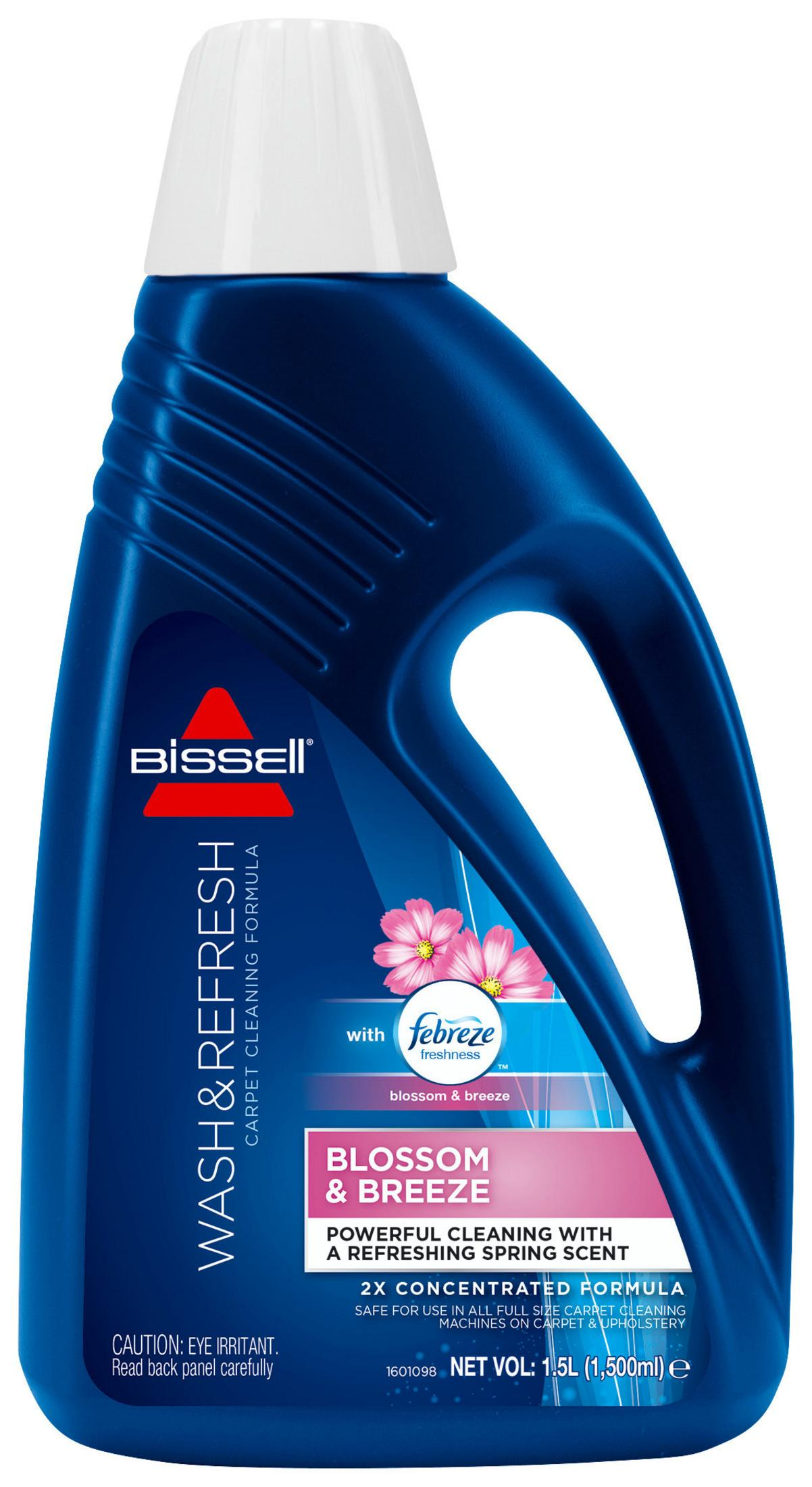 Bottiglia blu di formula per la pulizia dei tappeti Bissell, con etichetta Blossom & Breeze.