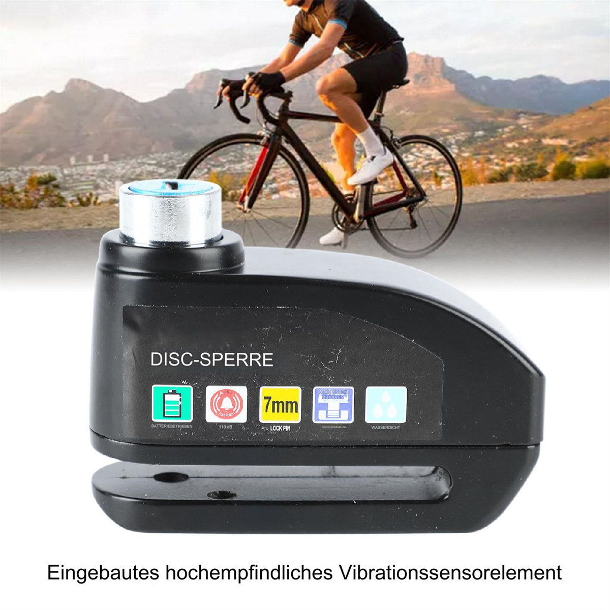 Ein schwarzes scheibenförmiges Fahrradschloss mit einem Berg im Hintergrund.