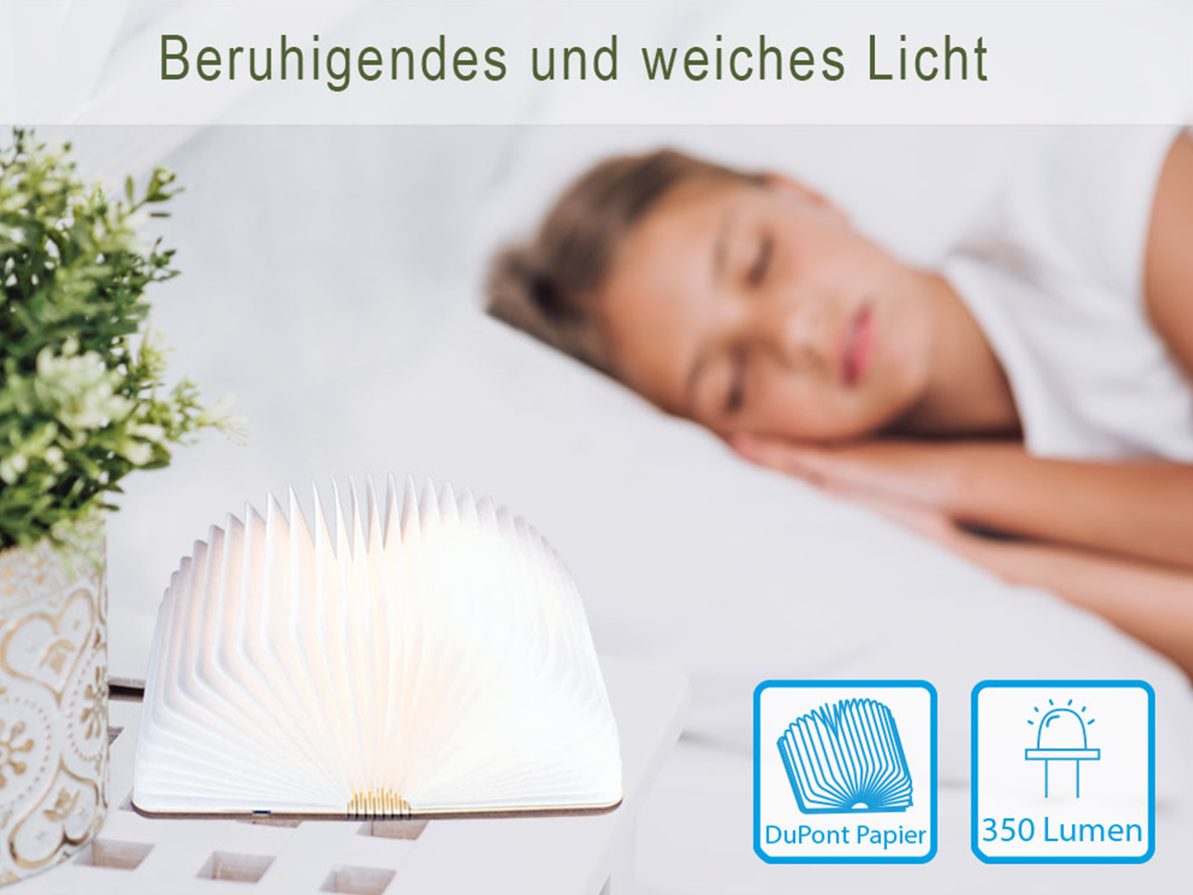 Una lampada a forma di libro emette luce calda, vicino a una persona che dorme.