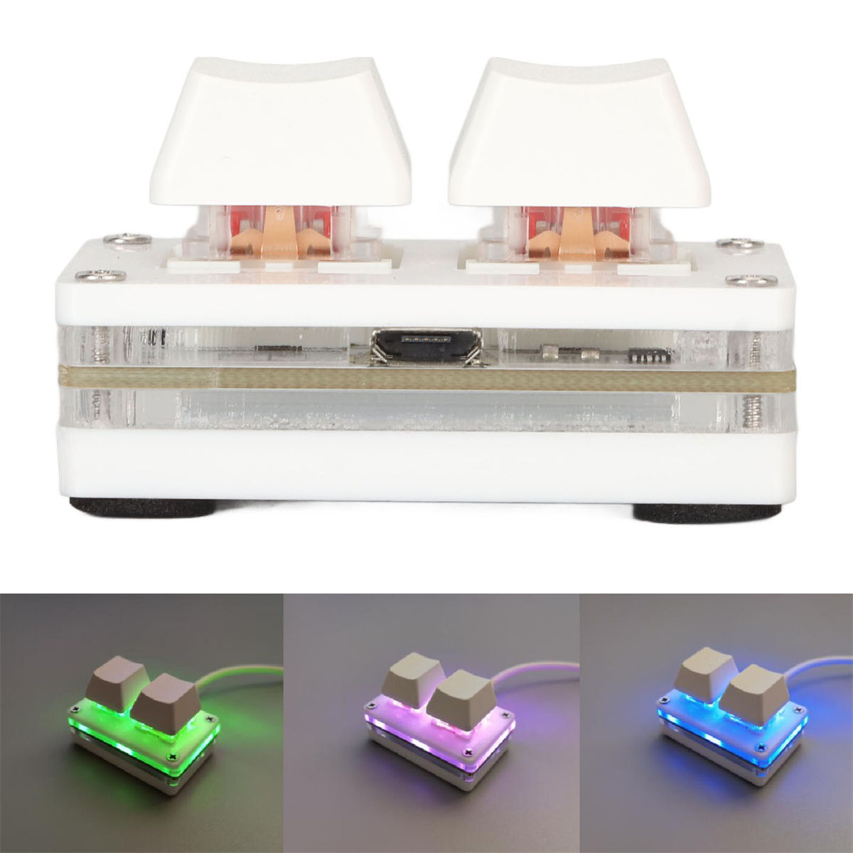 Eine weiße Tastatur mit zwei Tasten, beleuchtet durch grüne, lila und blaue Lichter.