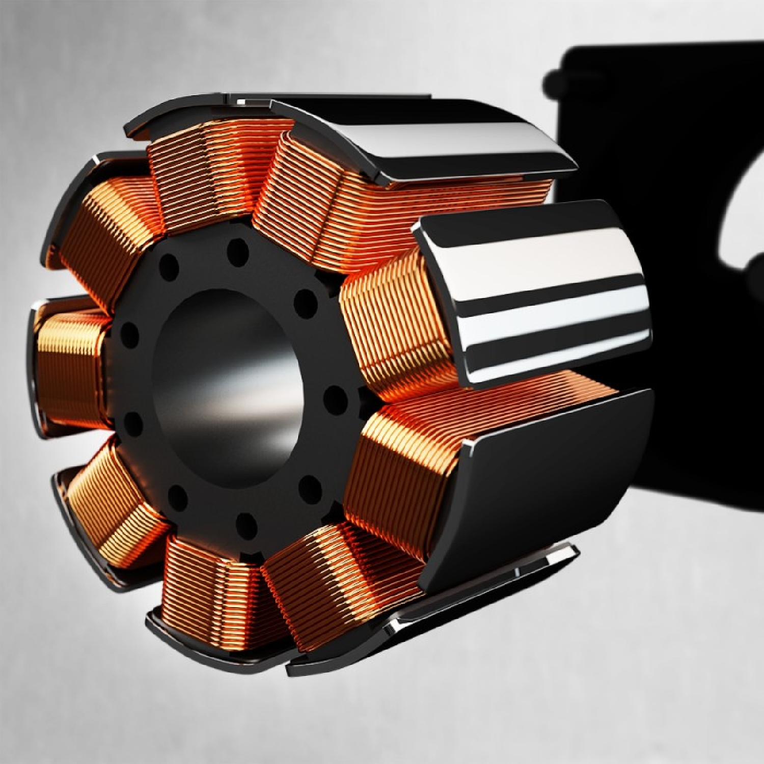 Zbliżenie wirnika z cewkami miedzianymi. Wirnik jest czarny, a cewki pomarańczowe.