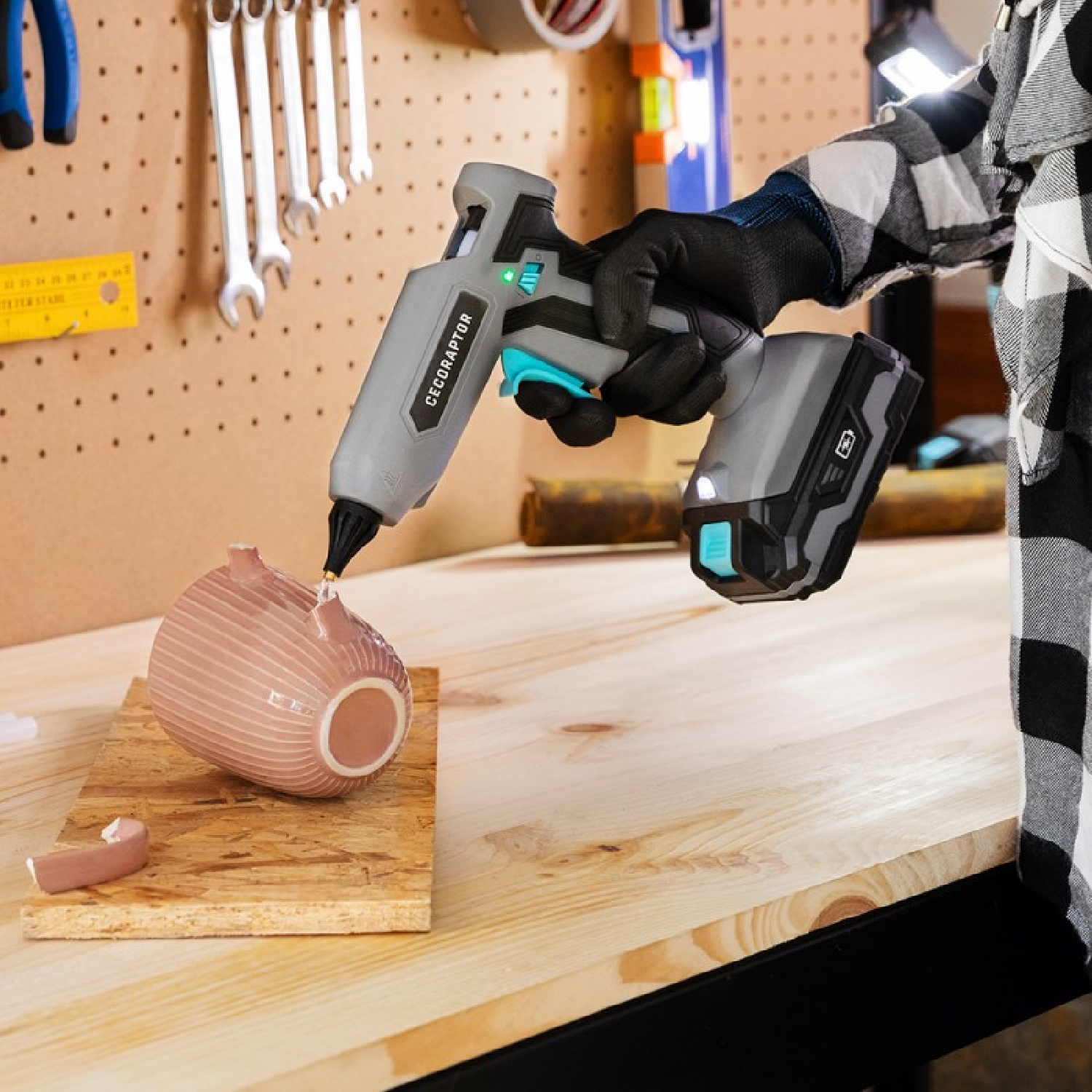 Osoba używająca pistoletu do klejenia Ceconraptor do naprawy ceramicznego przedmiotu.