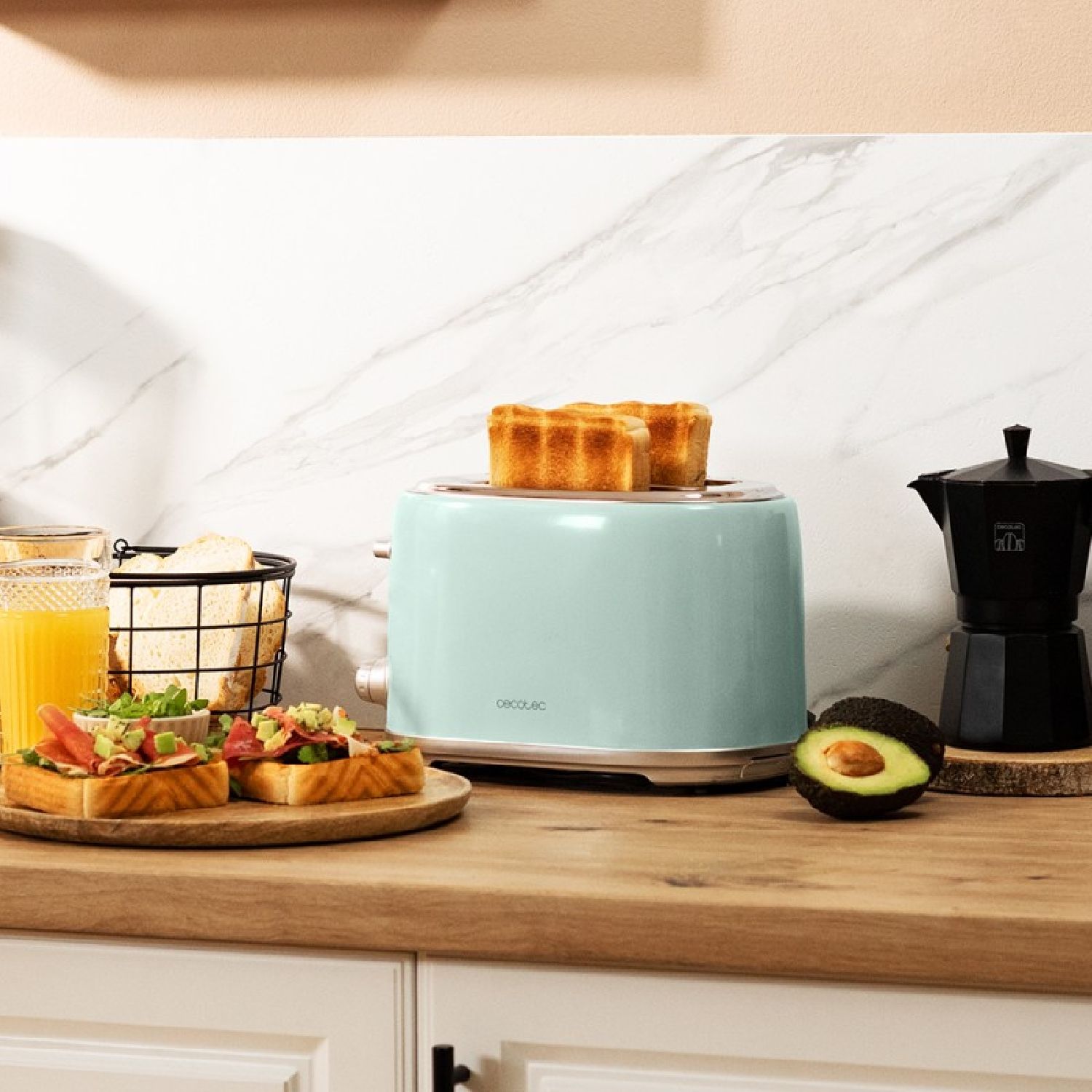 A countertop with a toaster, toast, and coffee maker. Also, there is avocado and other food.