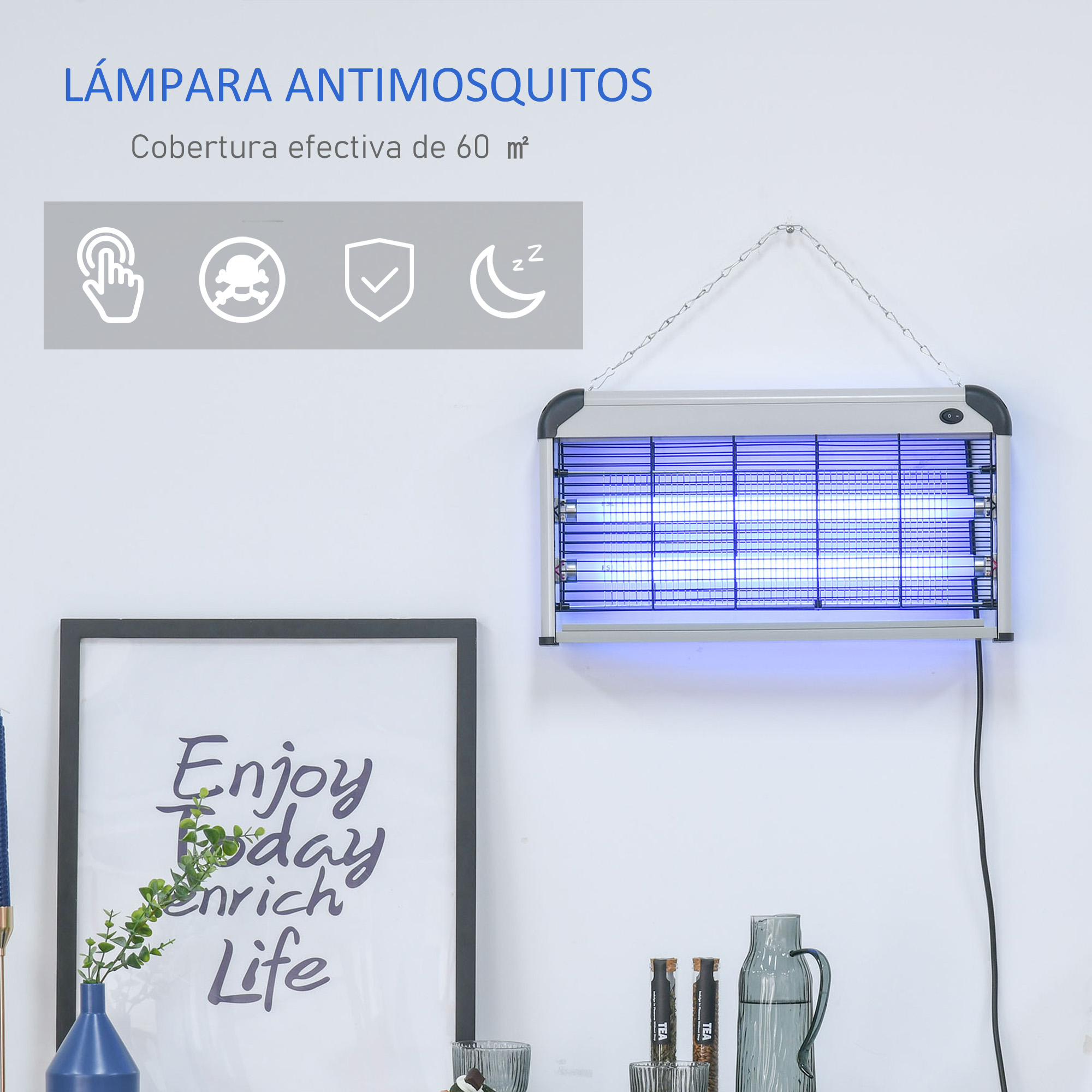 Una lámpara antimosquitos colgando, con una obra de arte enmarcada y un jarrón pequeño con planta.