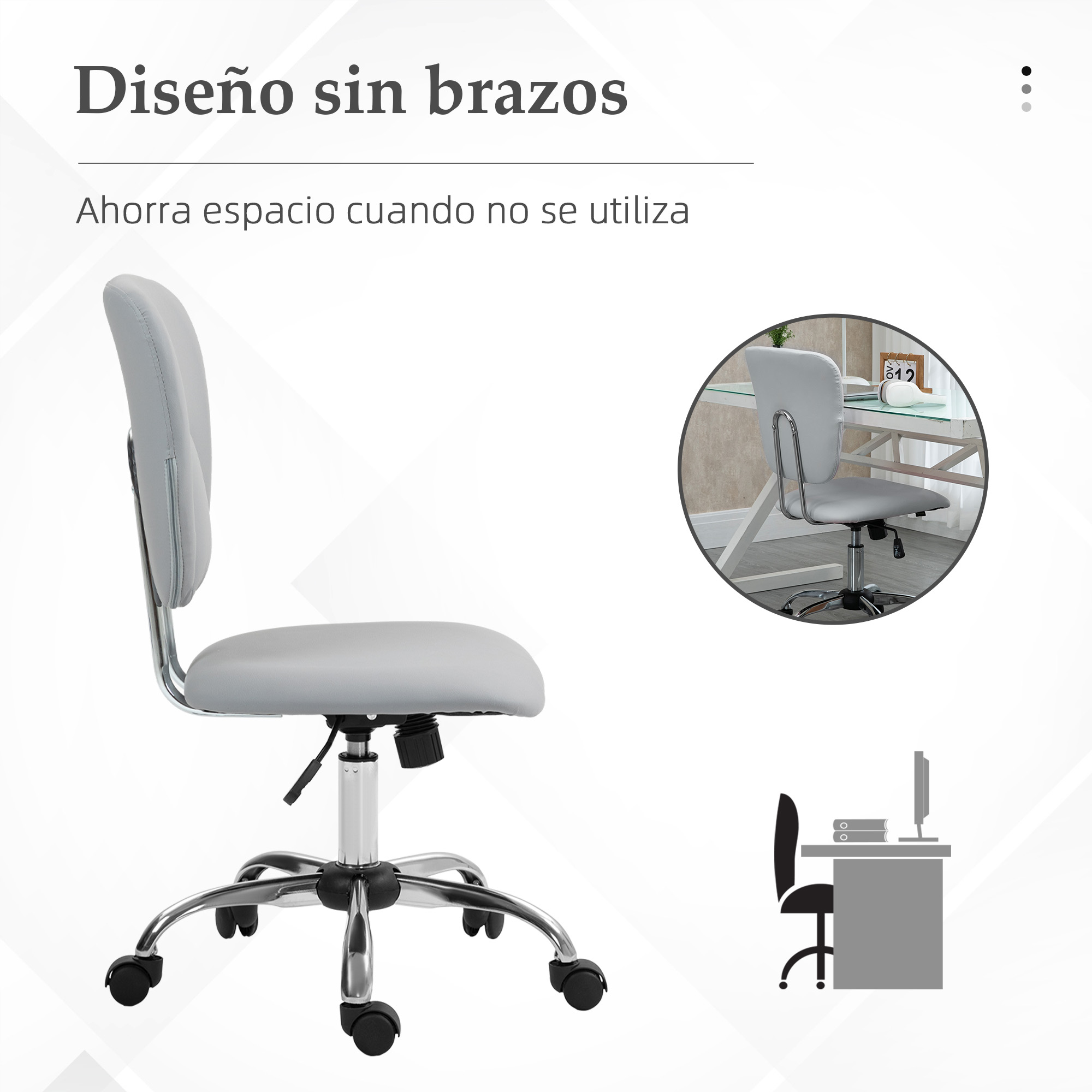 Una silla de oficina gris sin brazos con base y ruedas cromadas, junto a un escritorio pequeño con ordenador.