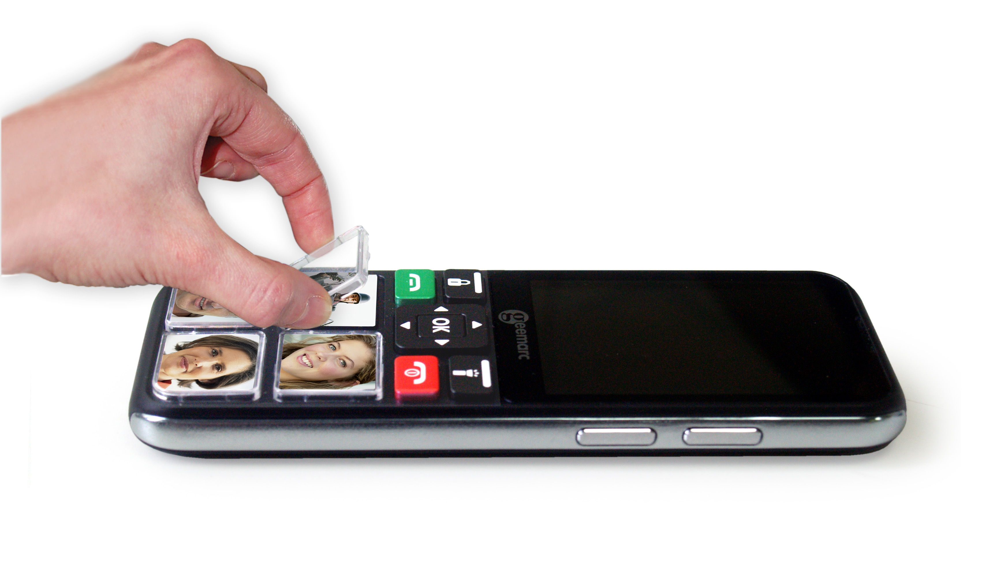 Hand removes a cover from a smartphone with large buttons.