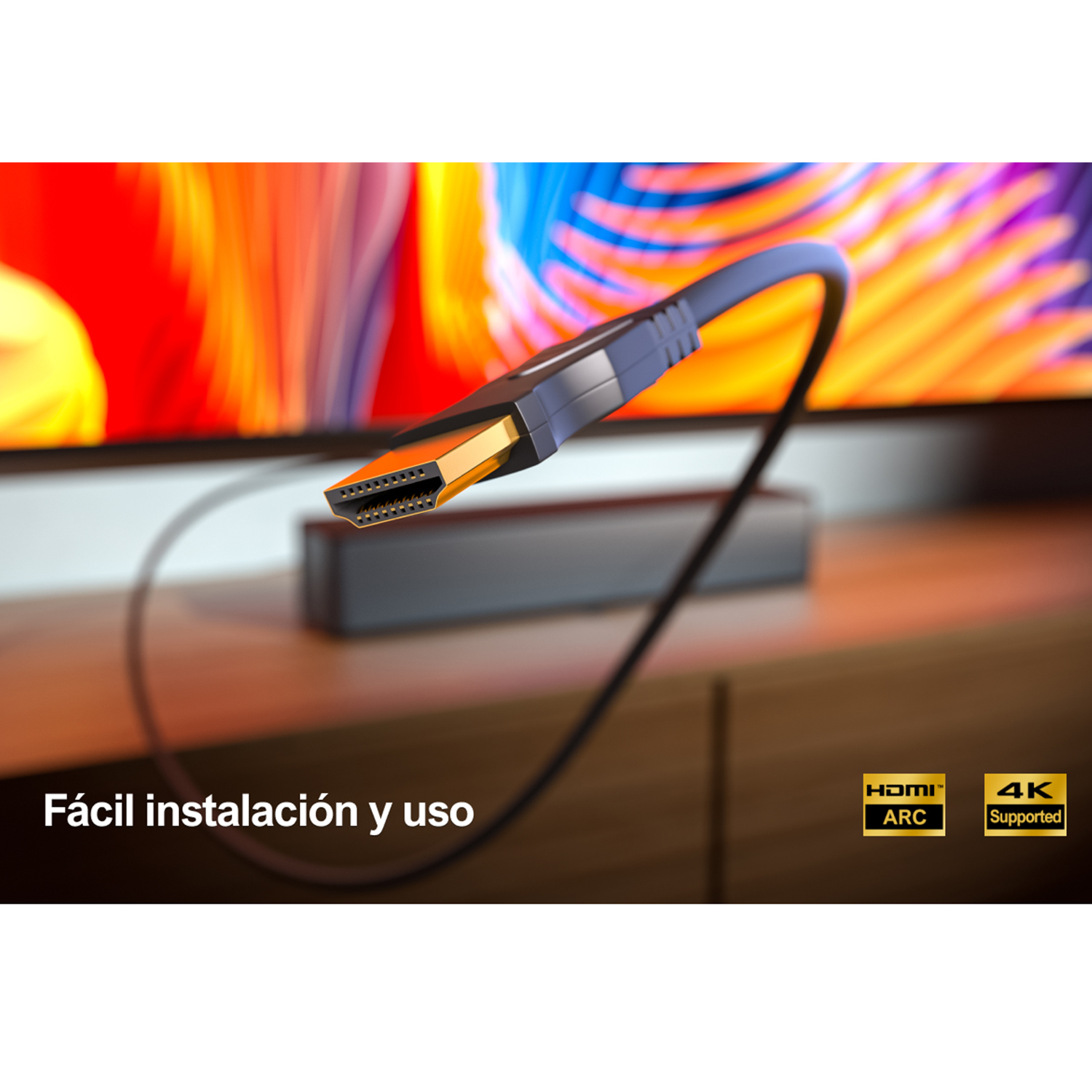 Cable HDMI conectado a un televisor. El cable es negro y naranja.