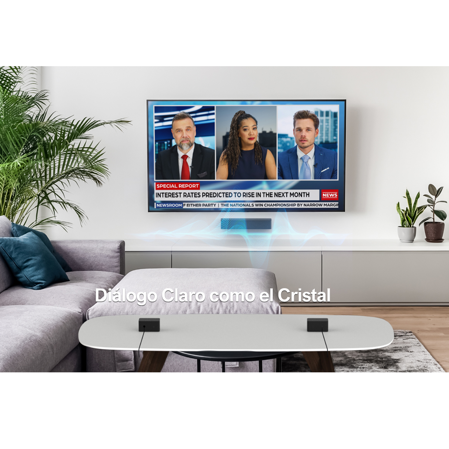 Un televisor que muestra noticias. Un sofá gris y una mesa blanca con dos dispositivos negros.