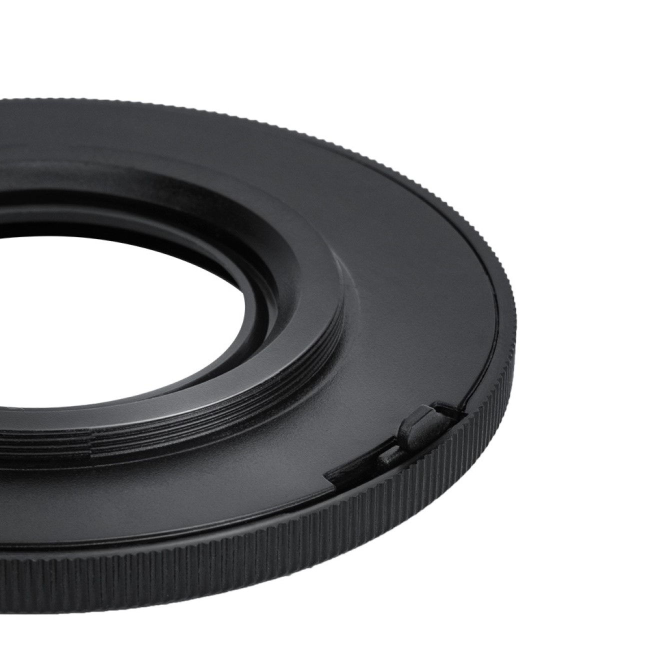 Schwarzer Objektivadapterring mit Gewinde und kleiner Lasche, vor weißem Hintergrund.