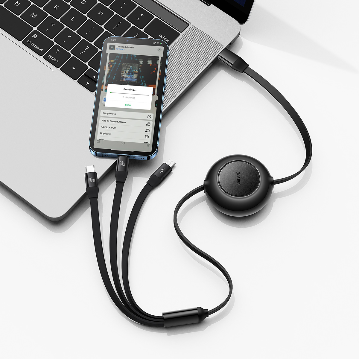 Smartphone connected to a laptop via USB. Phone displays a file transfer.