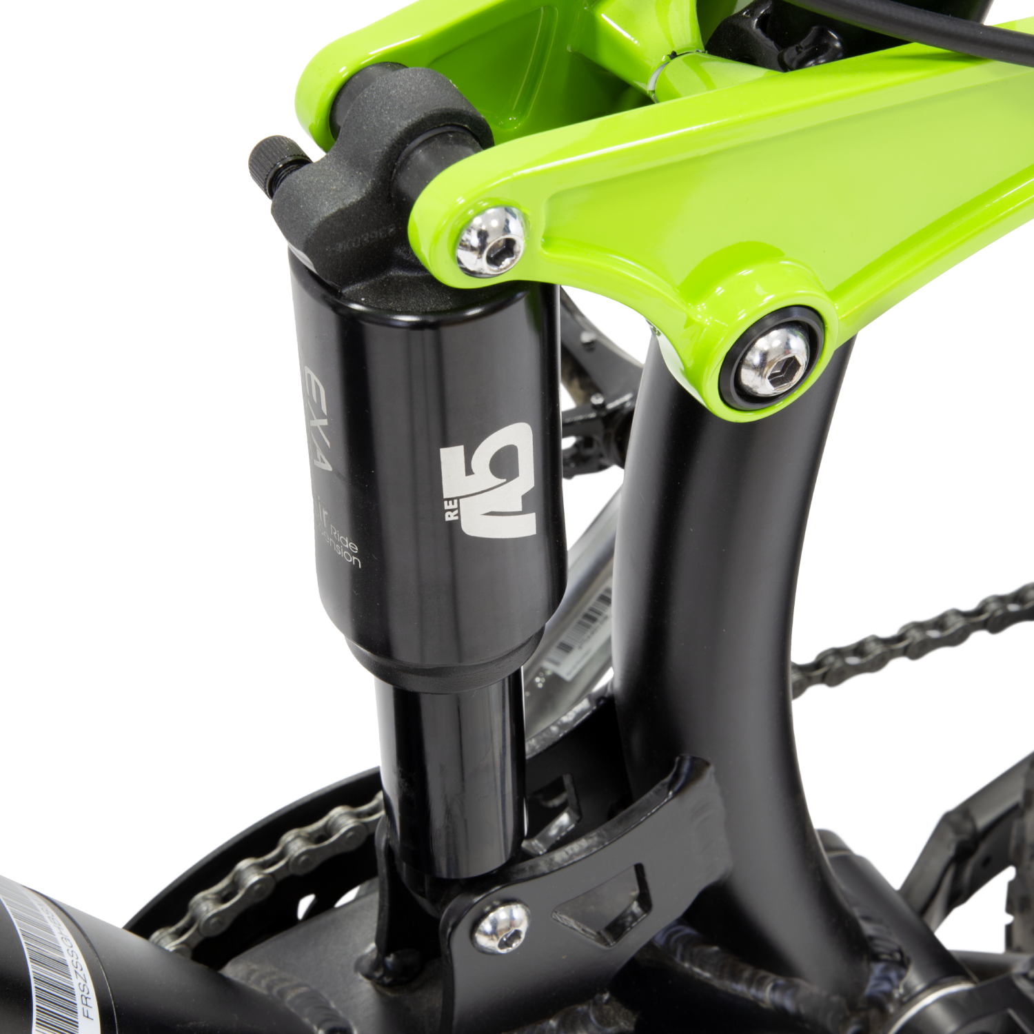 Gros plan sur le système de suspension d'un vélo. Composants vert citron et noirs visibles sur fond sombre.