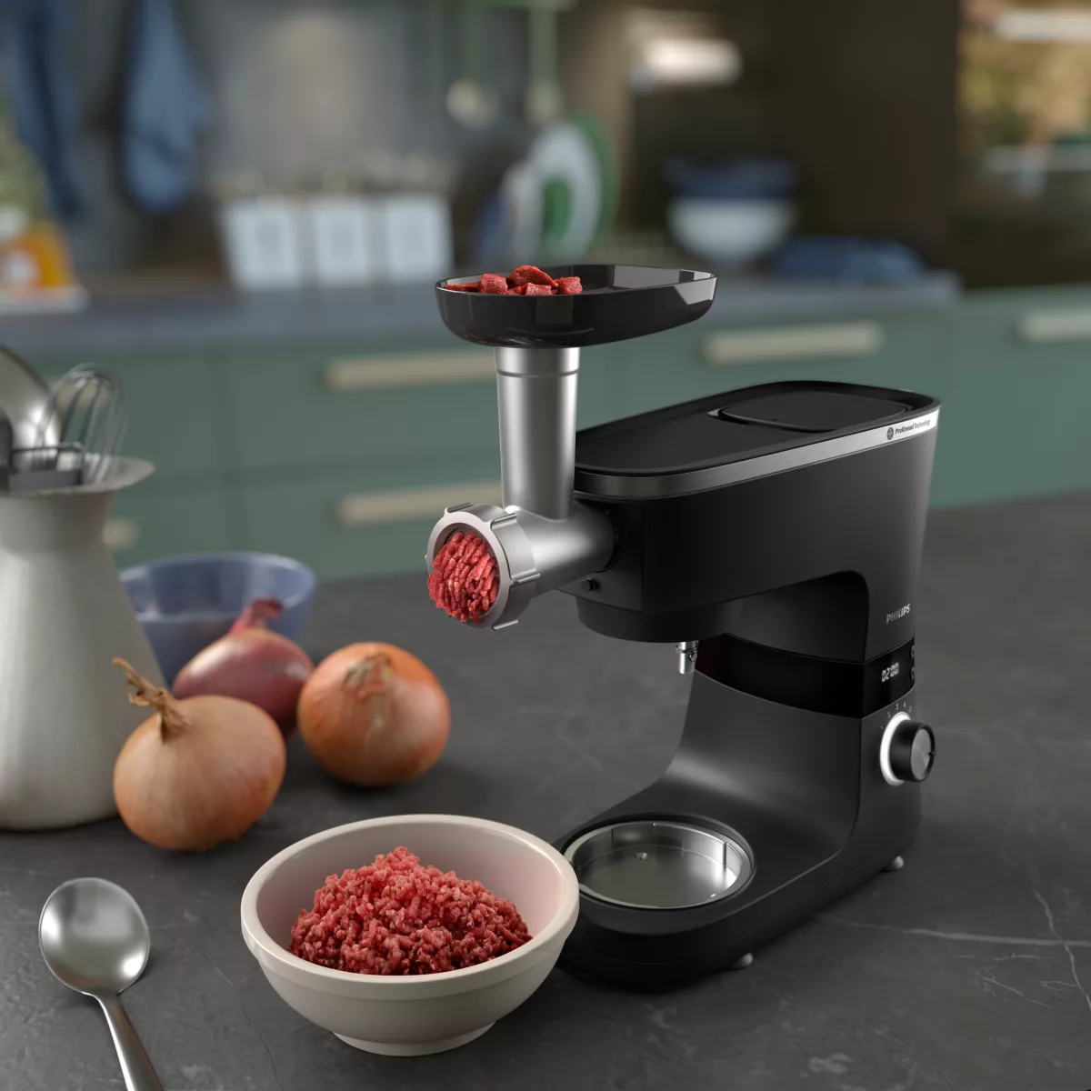 Eine schwarze Philips Küchenmaschine mit Fleischwolfaufsatz, Zutaten und Schüsseln auf einer Küchenarbeitsplatte.
