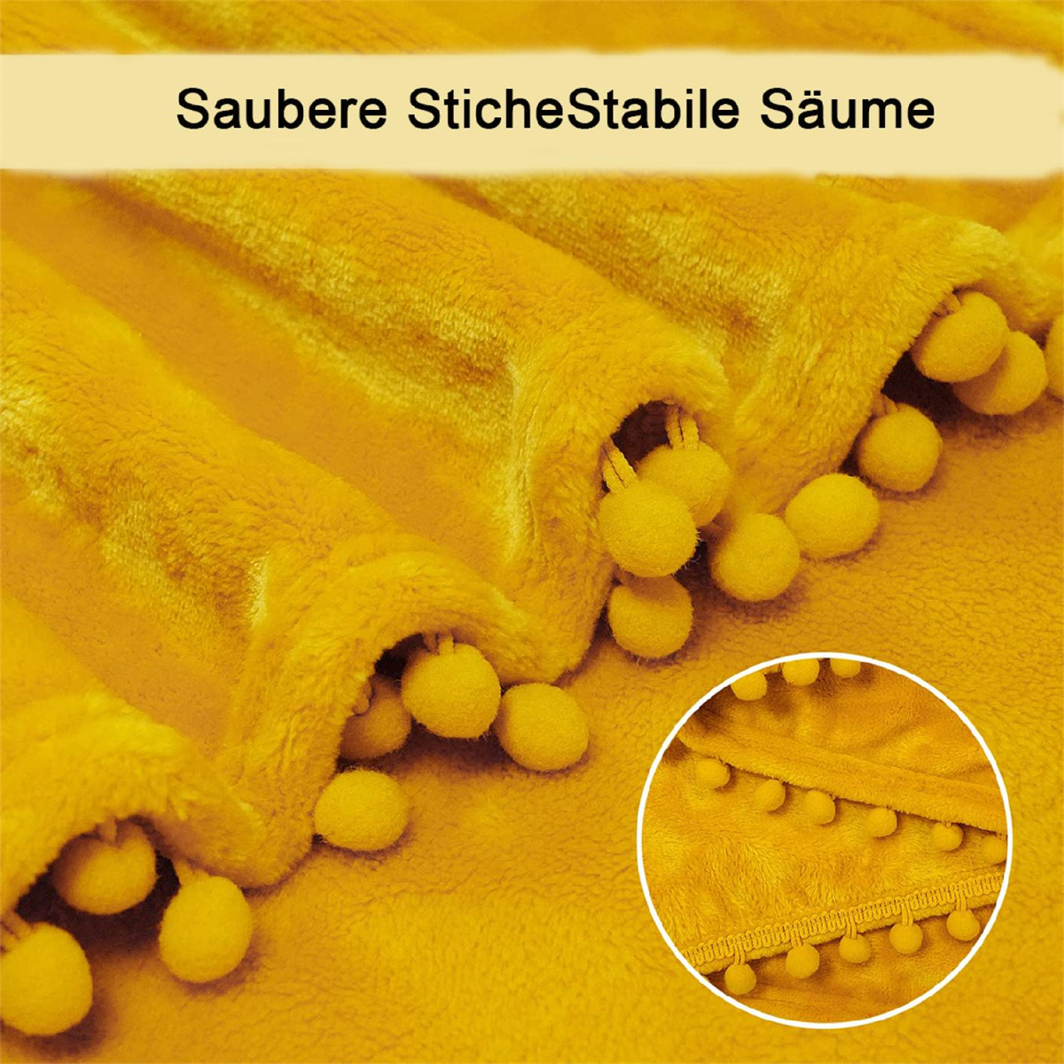 Nahaufnahme einer gelben Decke mit Fransen und Pompons.