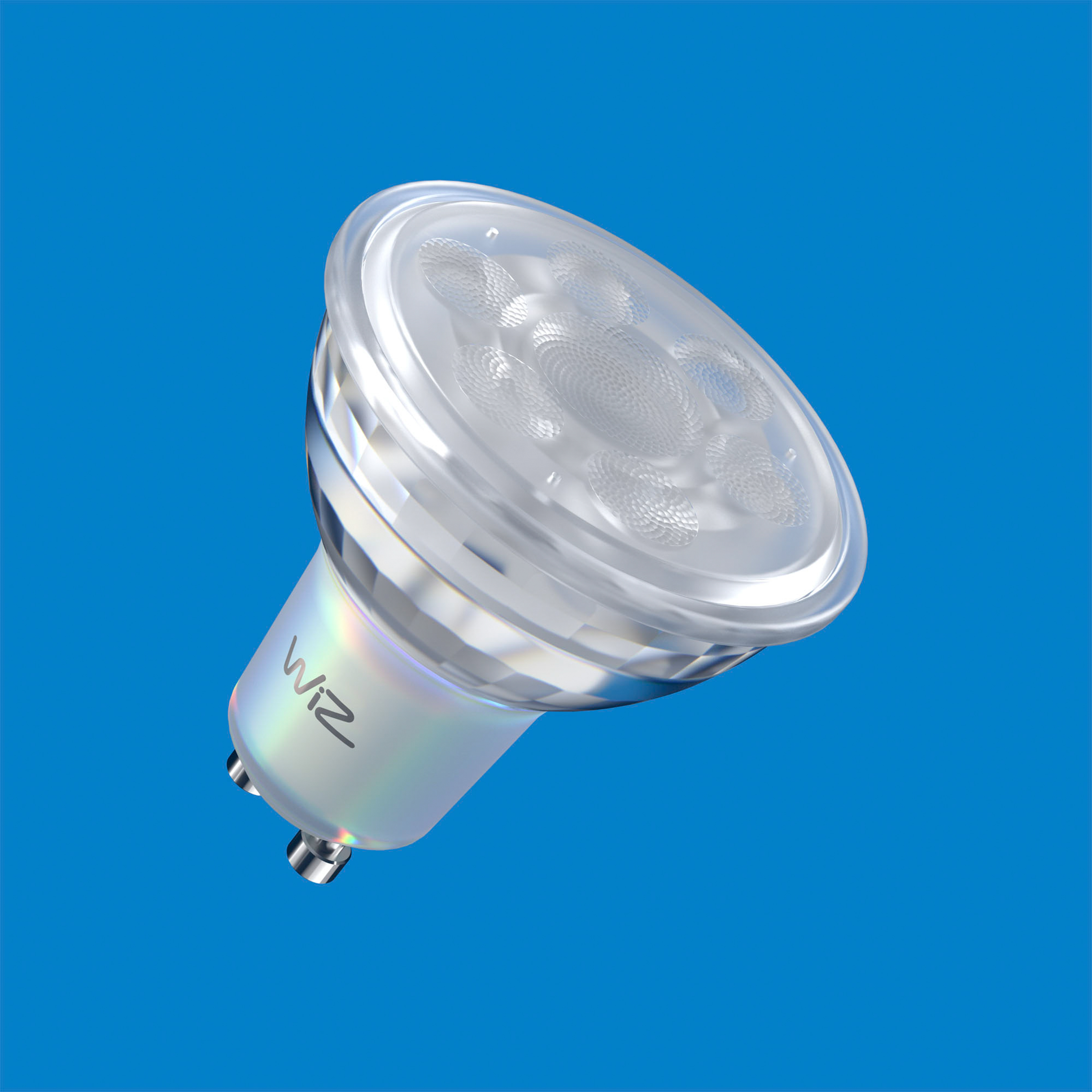 A close-up of a Wiz LED spotlight, against a blue background. The light has a clear cover.