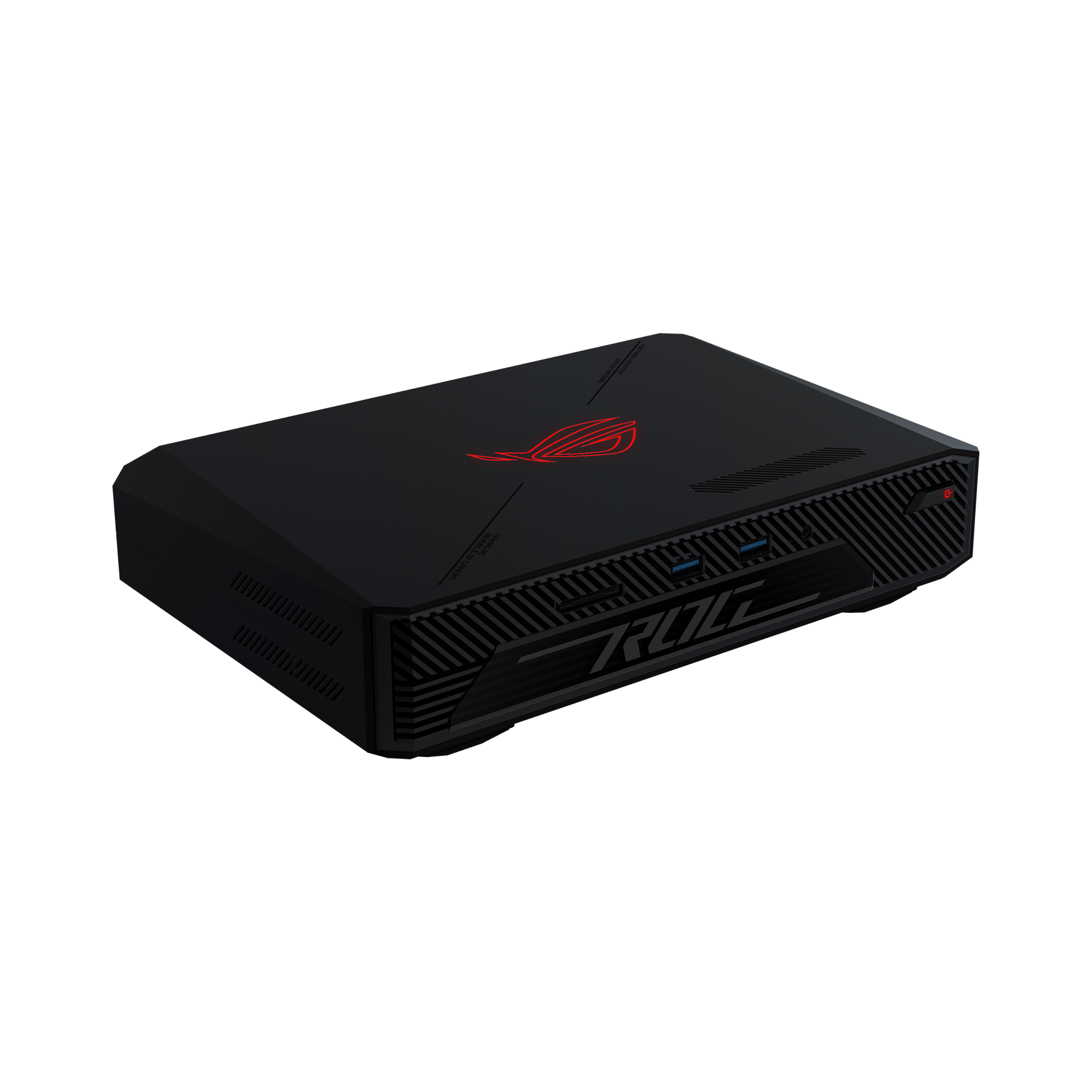 Czarny mini PC ROG z czerwonym logo, skośnymi bokami i tekstem. PC jest na białej powierzchni.