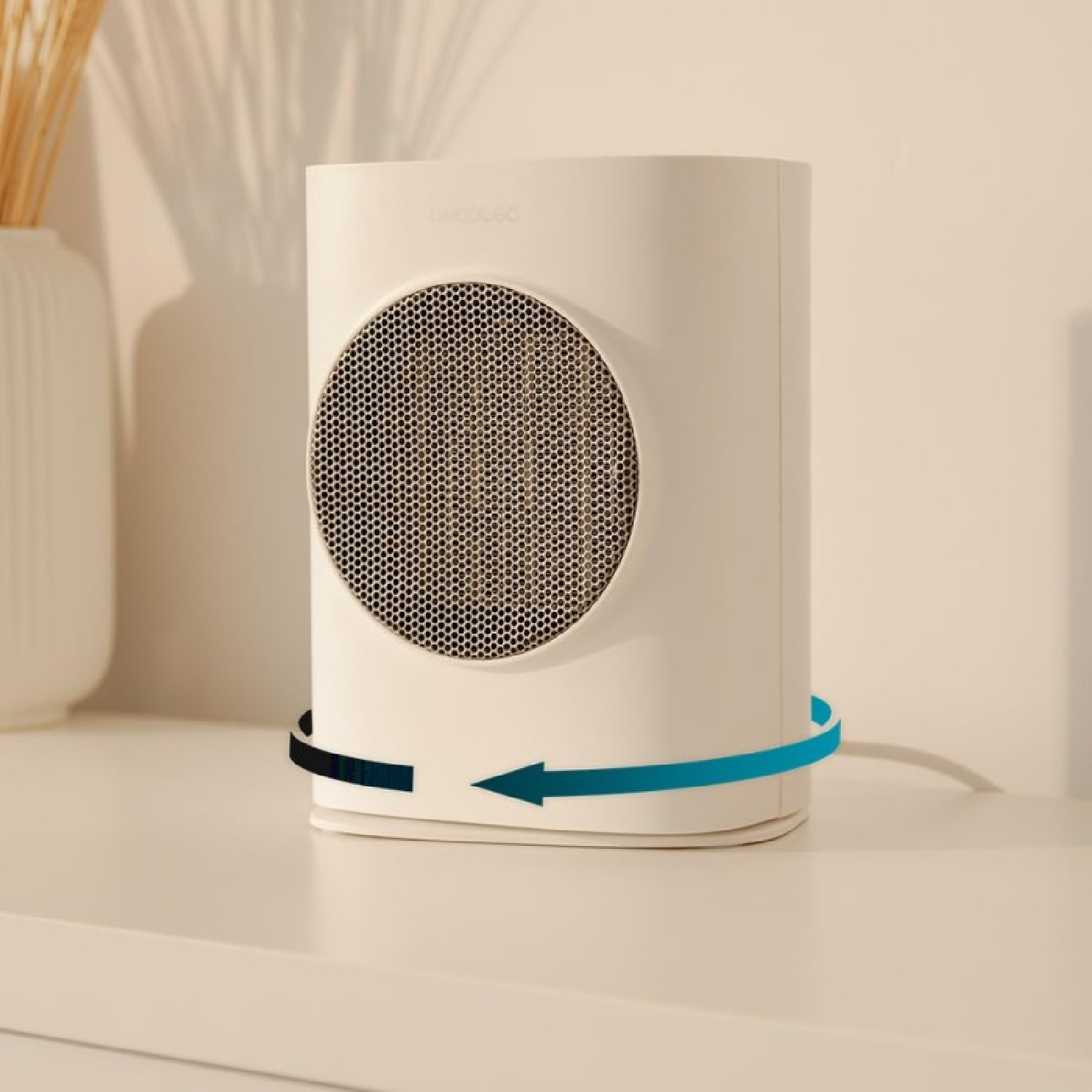 Termoventilatore Cecotec bianco, cilindrico con fronte a rete, su superficie bianca, con frecce.