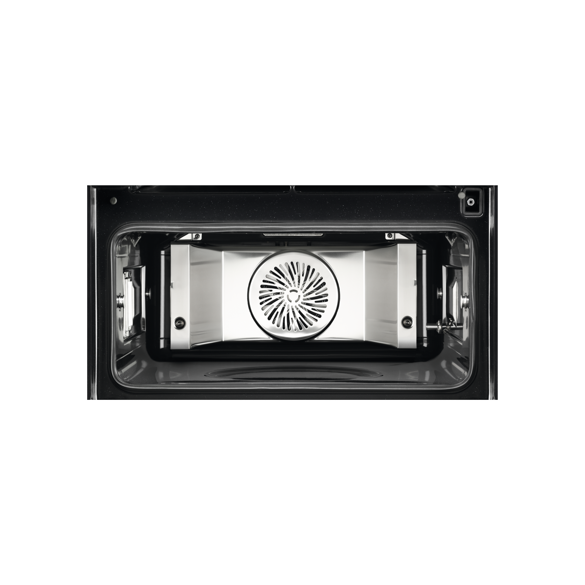 Interior de un horno. Un ventilador y elementos metálicos son visibles sobre fondo negro.
