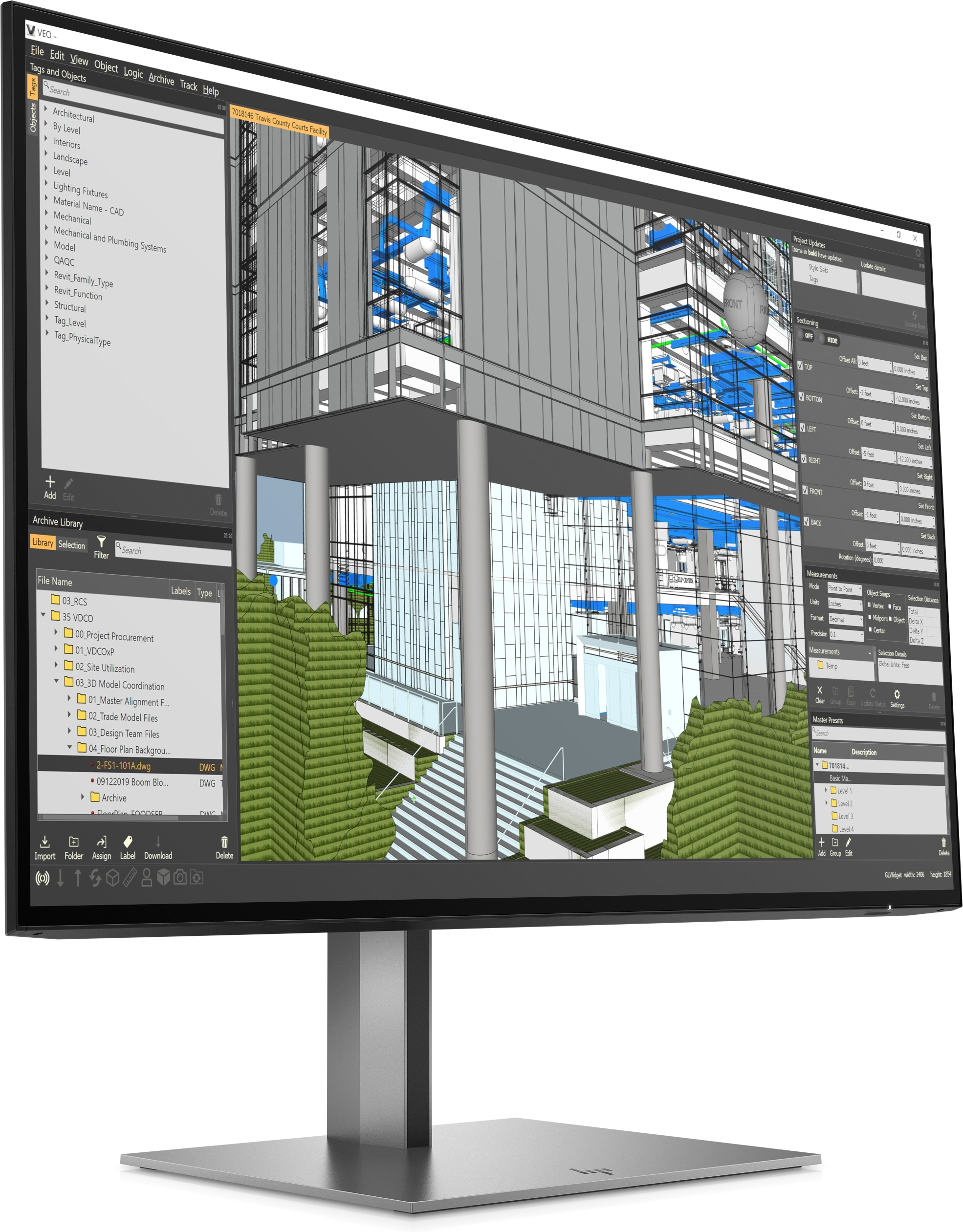Ein Computermonitor, der einen Bauplan mit einem großen grauen Gebäude und grünen Büschen zeigt.