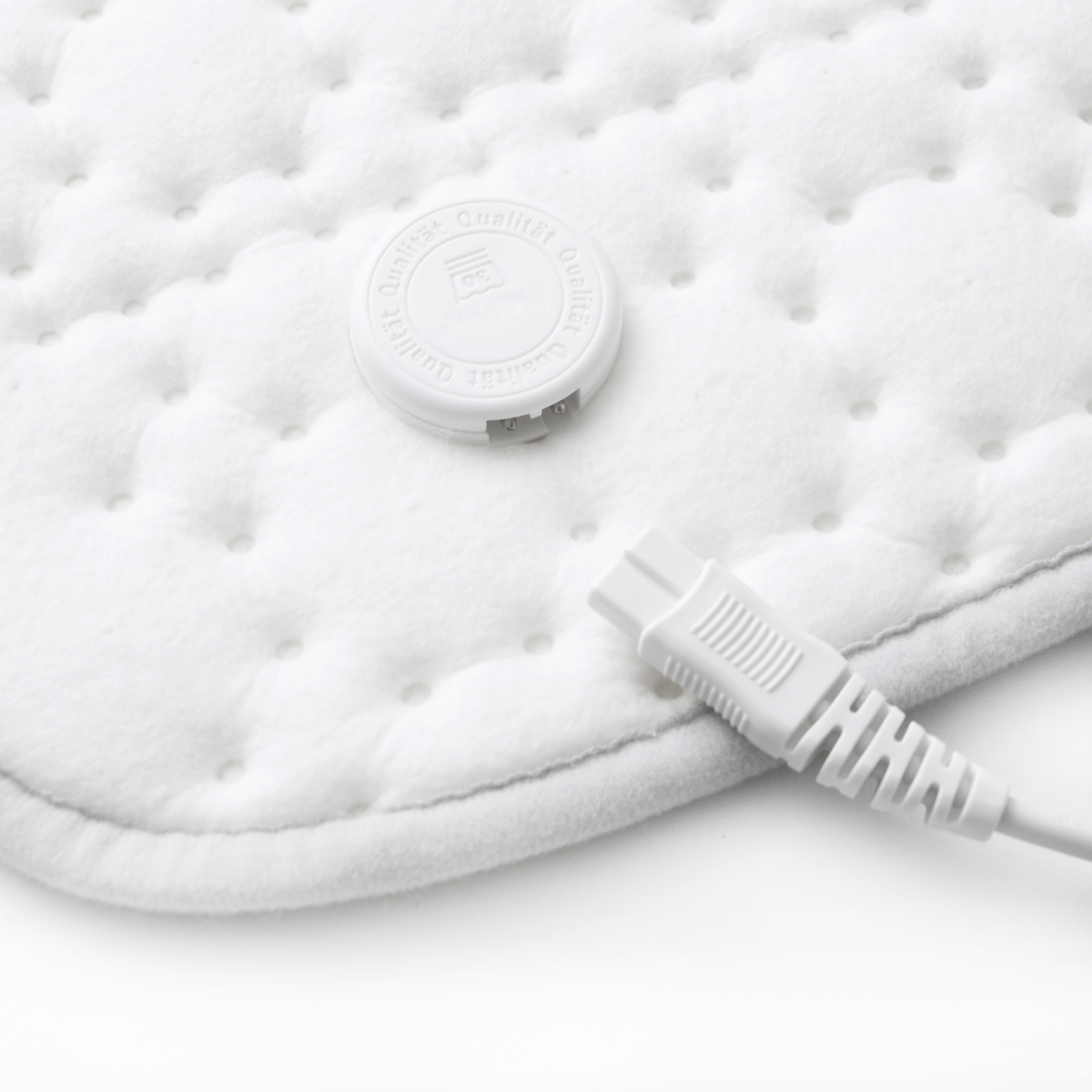 White electric heated blanket with a control dial and a power cord.