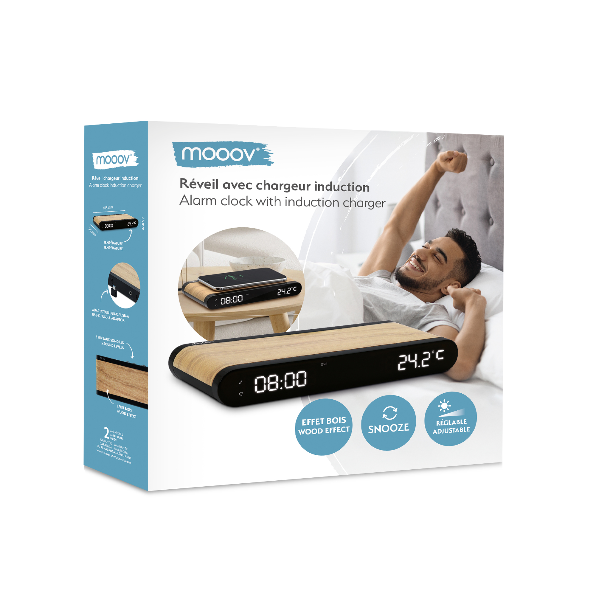 Caja de producto con un hombre durmiendo en una cama con un despertador efecto madera y un teléfono.