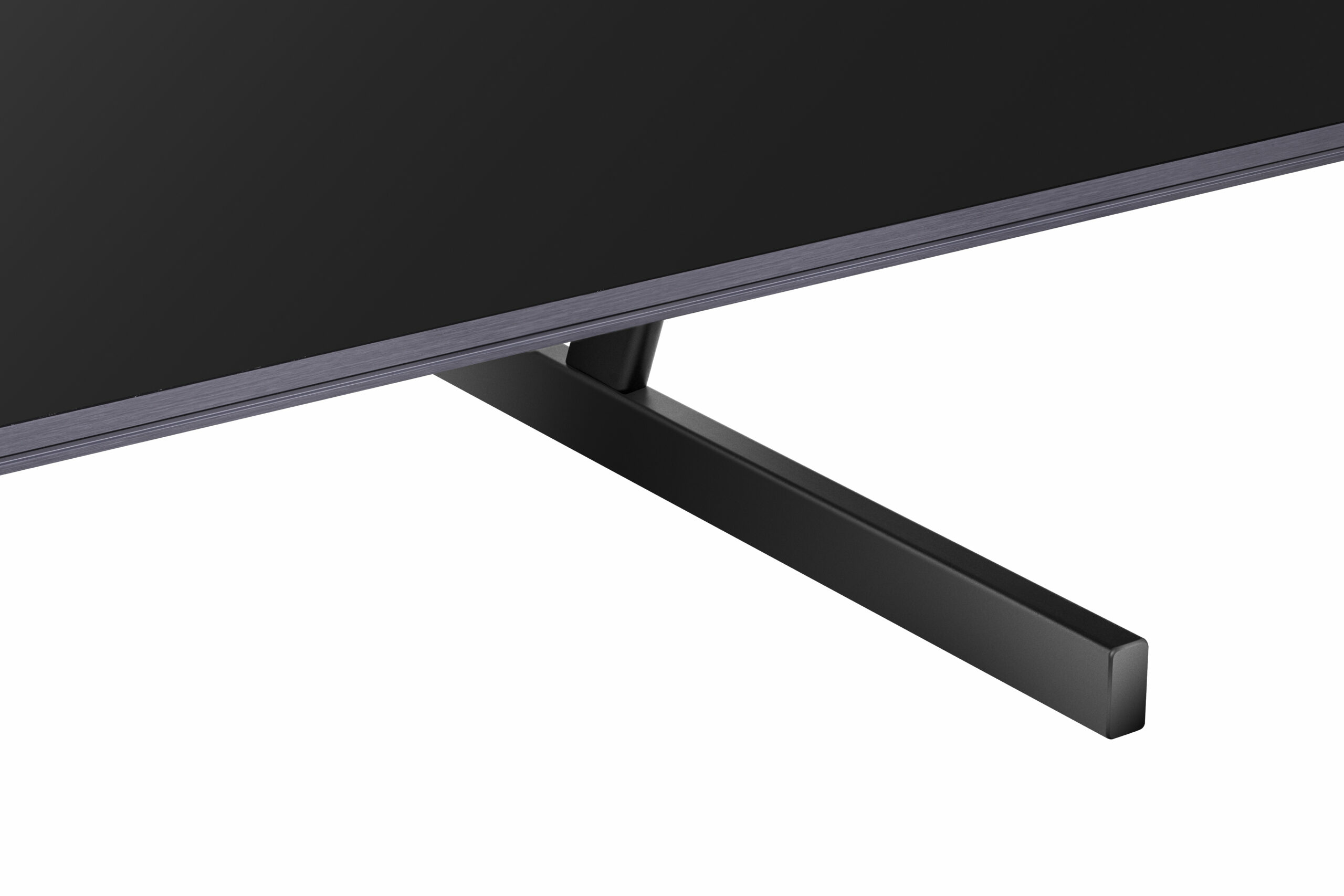 Zbliżenie czarnej podstawy telewizora, z szeroką, płaską podstawą i strukturą wspierającą.