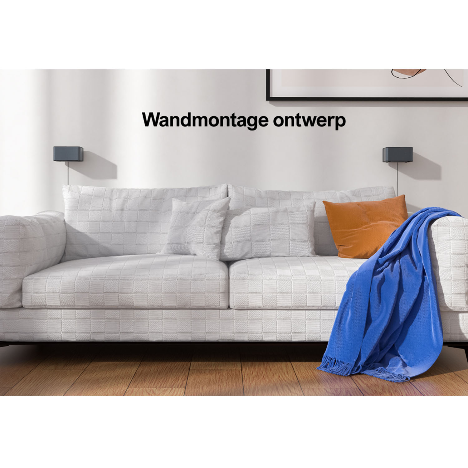 White sofa with orange pillow and blue blanket, with wall-mounted speakers.