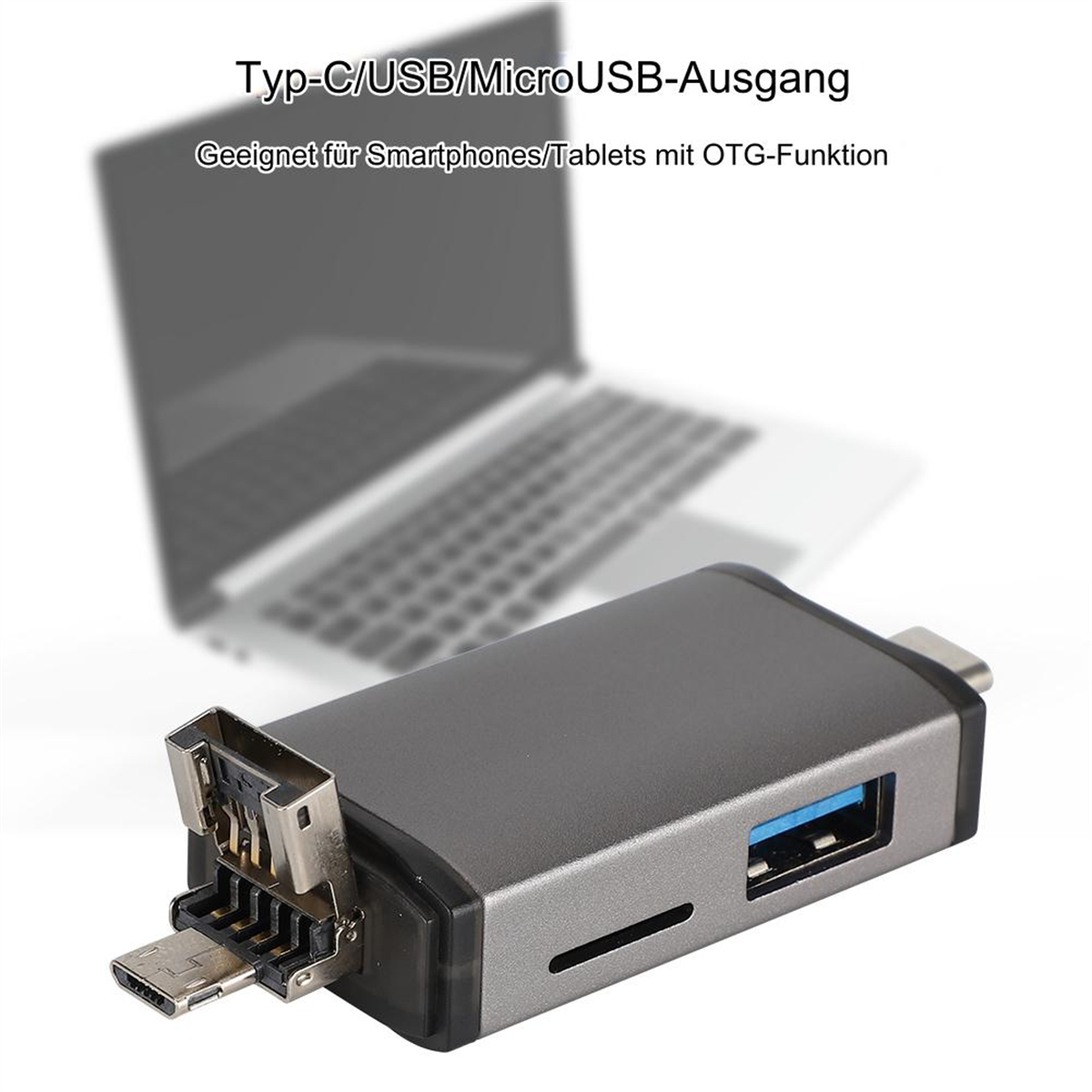 Grauer USB-Hub mit mehreren Anschlüssen, Laptop im unscharfen Hintergrund. Text: Typ-C/USB/MicroUSB.