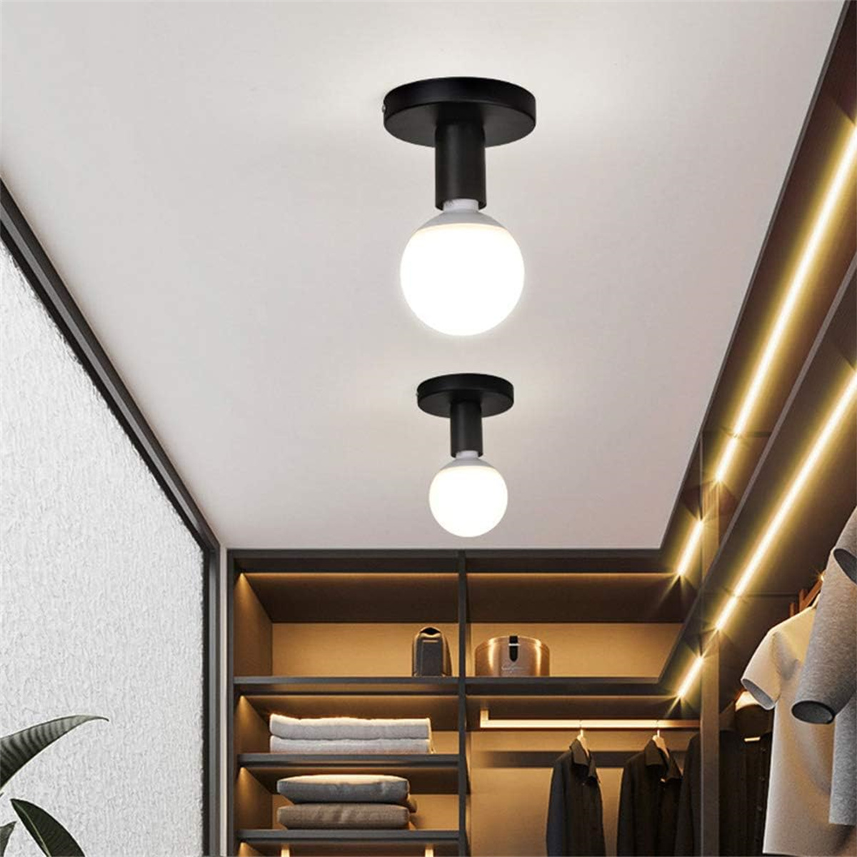 Zwei weiße Kugelleuchten an einer weißen Decke. Ein Schrank mit Regalen und Kleidern ist sichtbar.