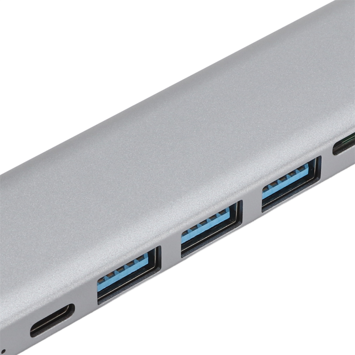 Silberner USB-Hub mit mehreren blauen USB-Anschlüssen. Nahaufnahme. Weißer Hintergrund.