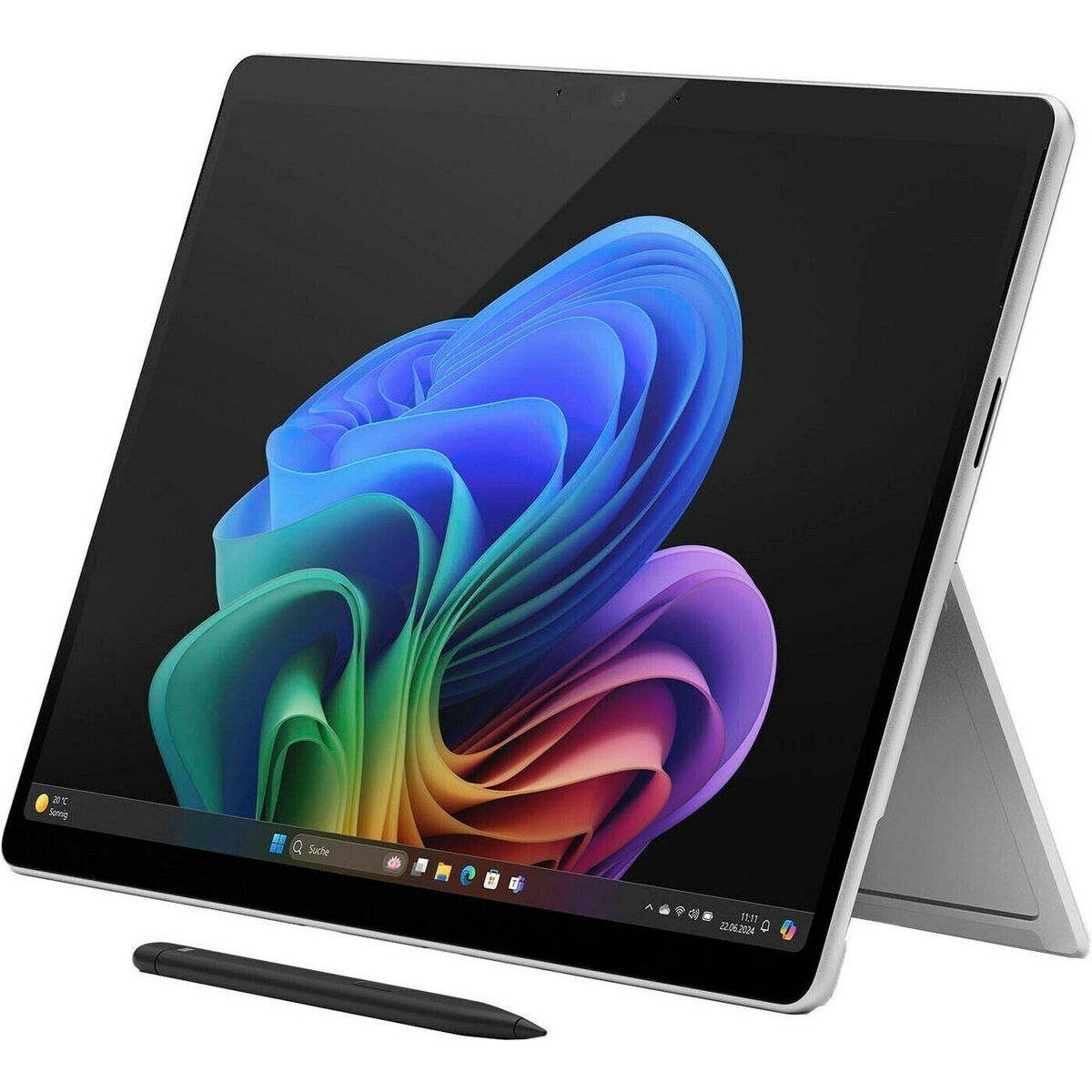 Laptop z kolorowym tłem i czarnym długopisem na białej powierzchni.