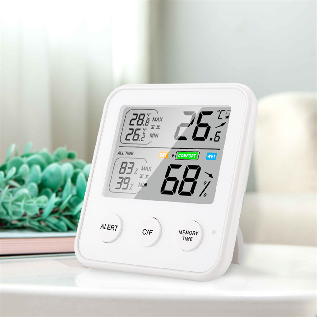 Weiße Digitalanzeige. Zeigt Temperatur, Luftfeuchtigkeit und Komfortniveau an. C/F, Alarm-, Speicher-Tasten.