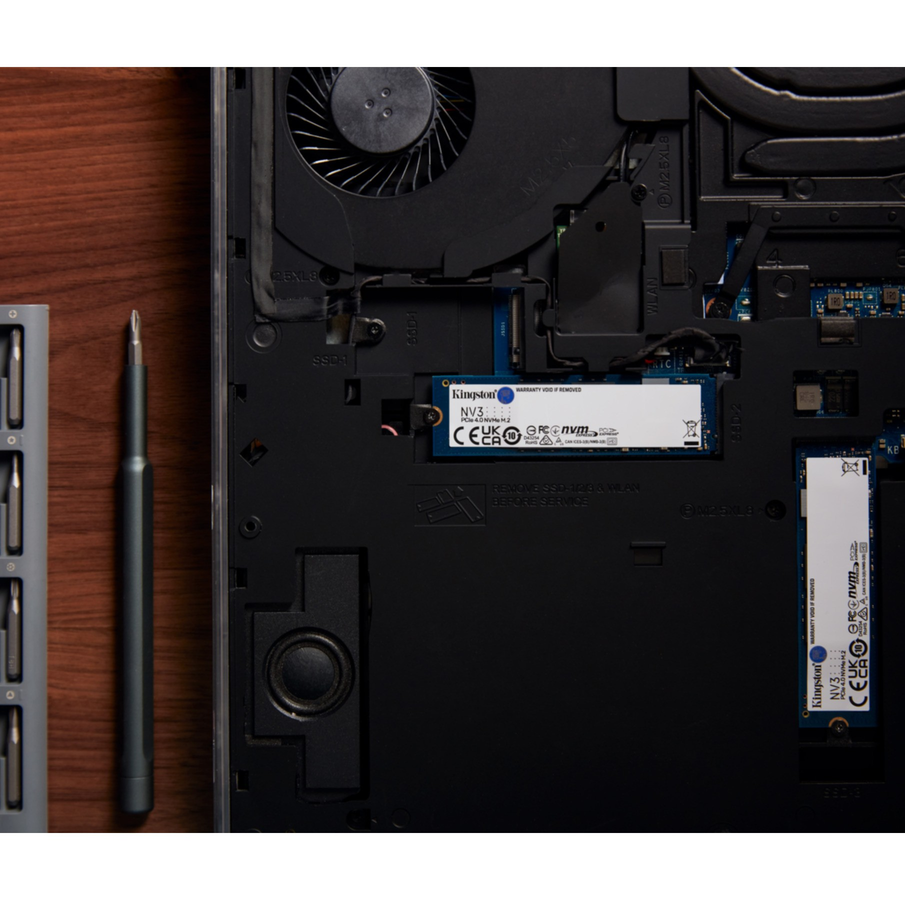 Wnętrze laptopa z zainstalowanym dyskiem SSD, obok śrubokręt.